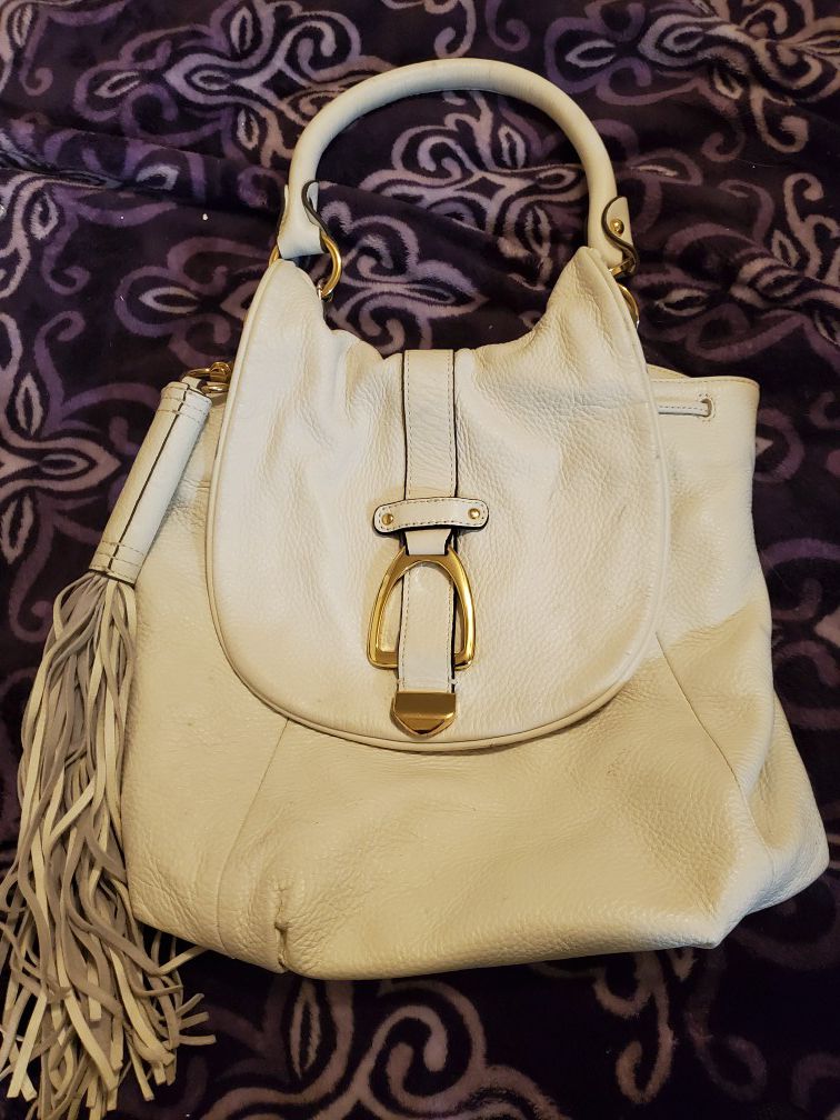100% real a leather purse/backpack has removable backpack straps and tassel. Can use as purse or backpack!