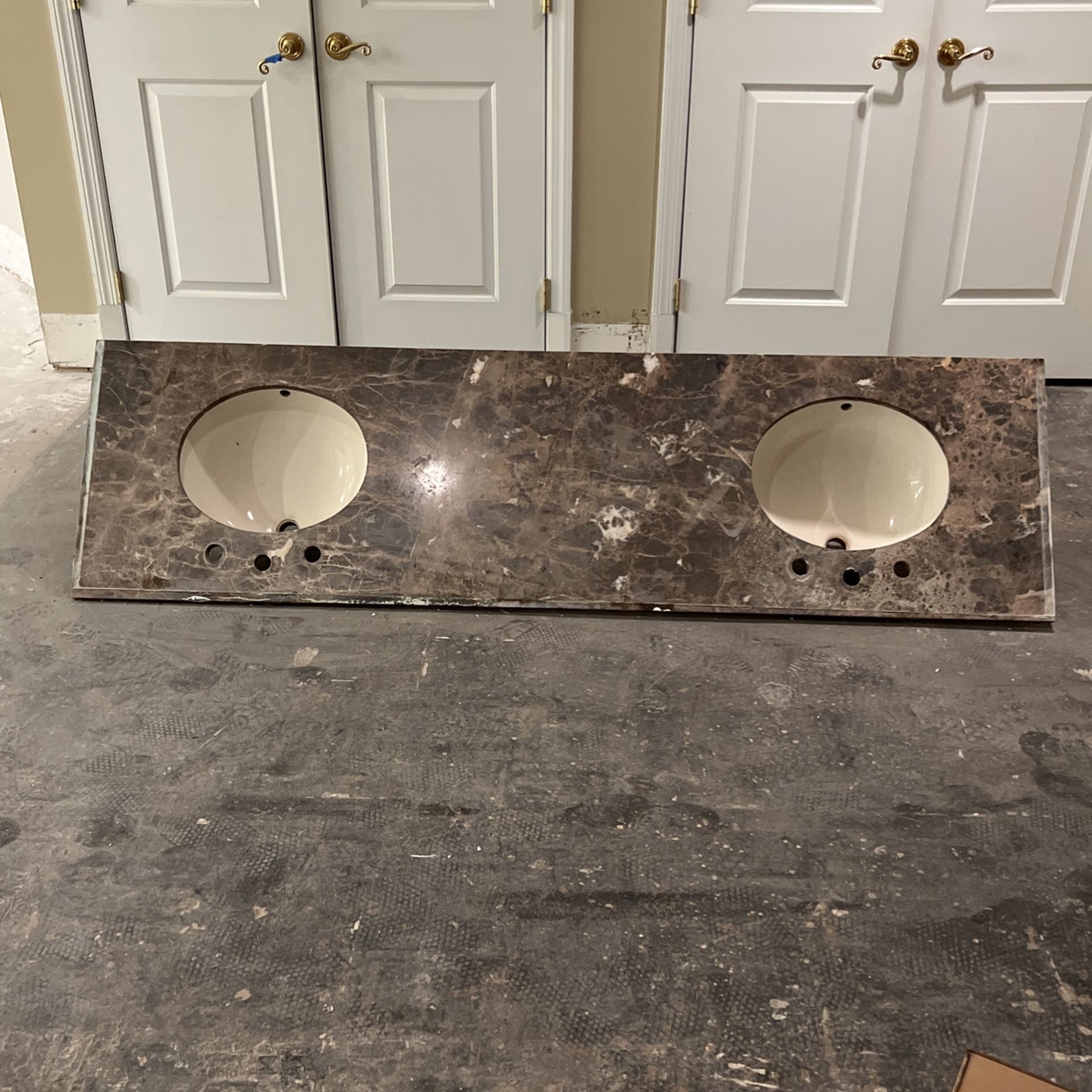 Brown marble top with ivory sinks. 79 inches wide.