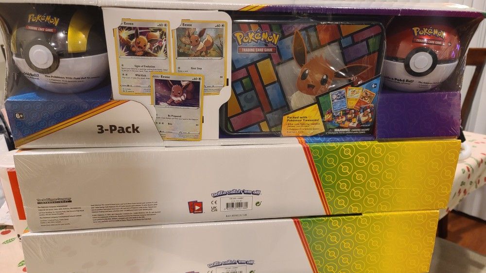 Pokemon 3 Pack Eevee Tin Box and 2 Pokemon Balls.