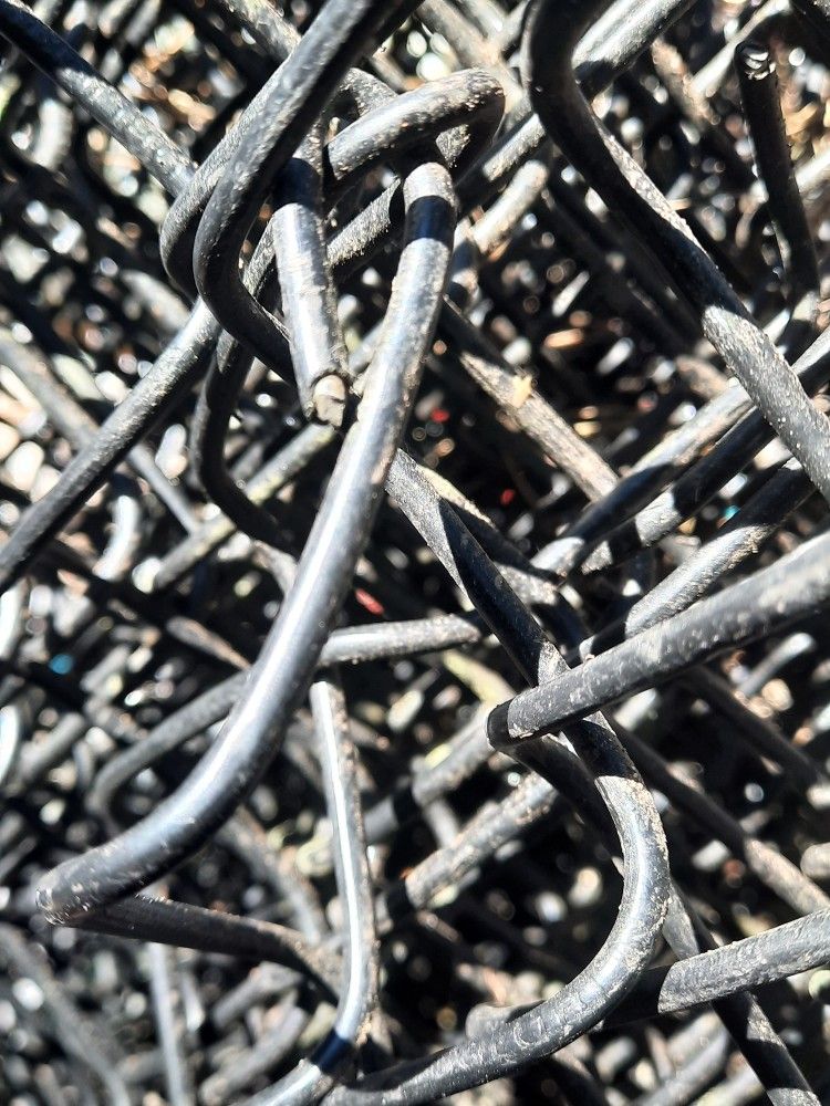 A Roll Of Black Vinyl Coated 4' Chainlink Fence