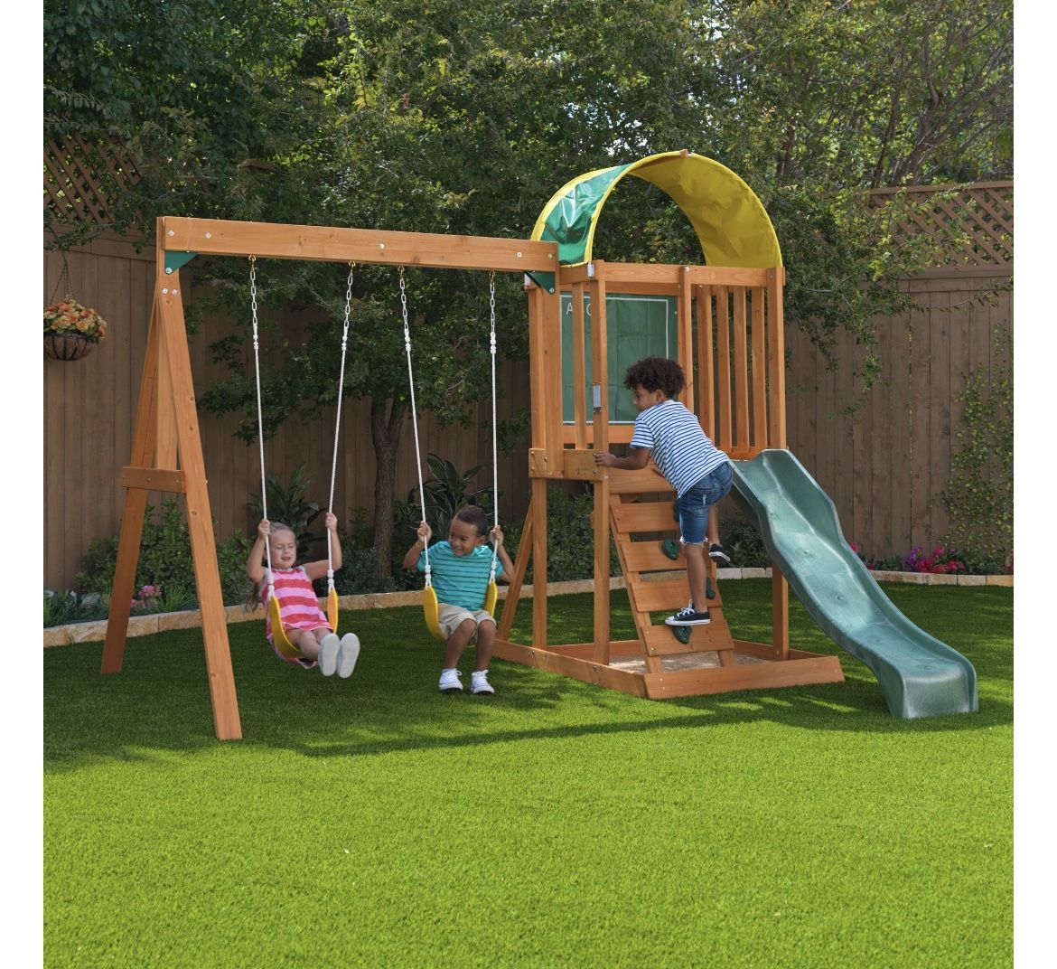 KidKraft Ainsley Wooden Outdoor Swing Set with Slide, Chalk Wall, Canopy and Rock Wall