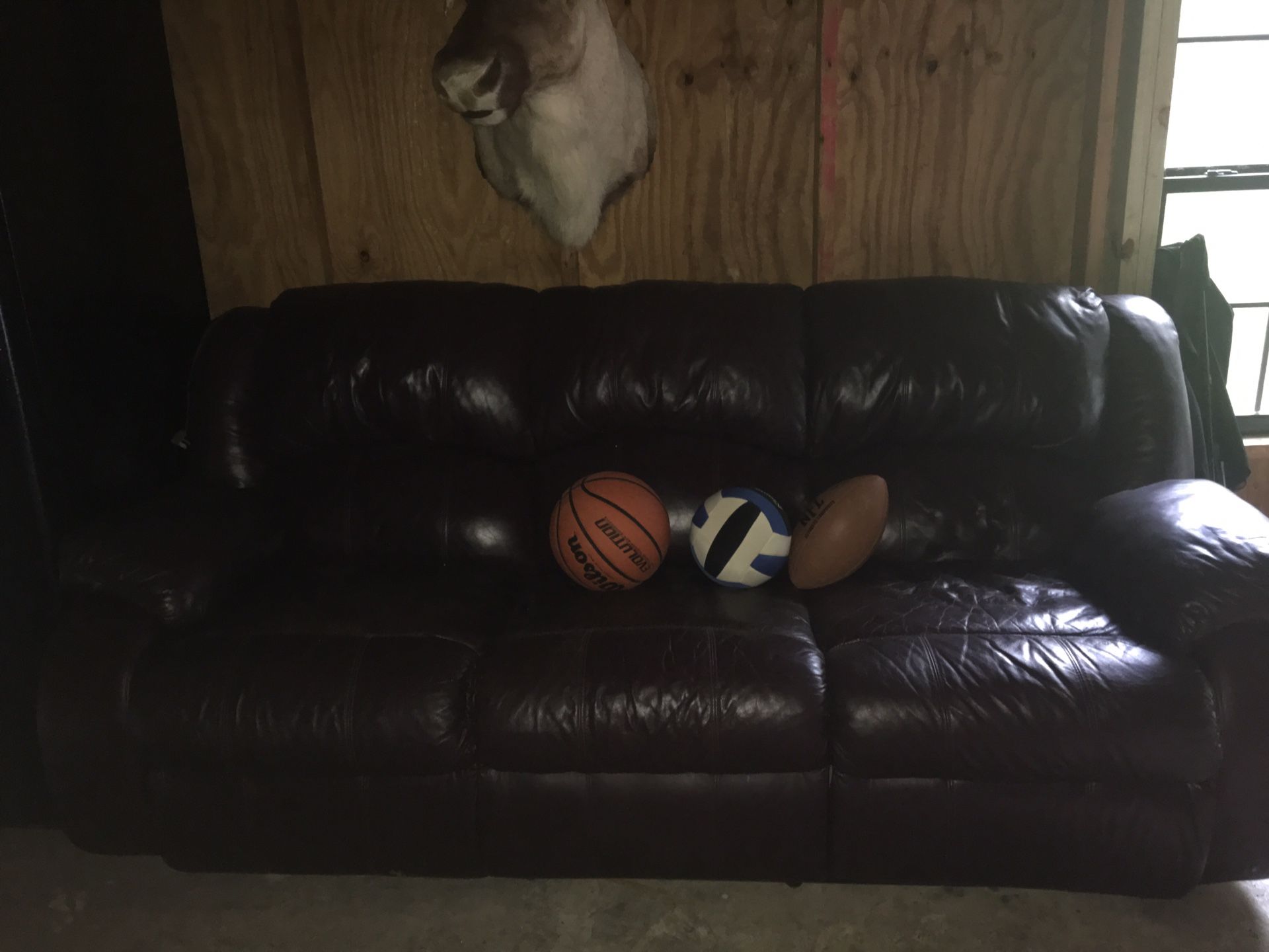 Real leather sofa with recliner on each end