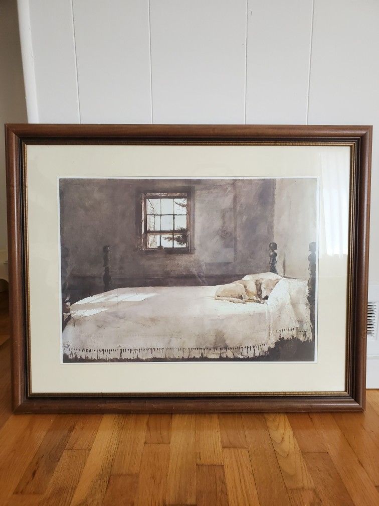 A dog in a bed Framed Art