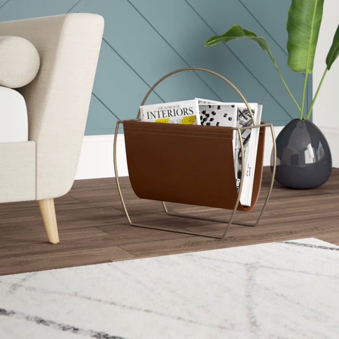 Hardage magazine rack by Mercury Row. Overall: 23” H x 22” W x 10” D. Faux leather. MSRP: $300. Our price: $95 + Sales tax