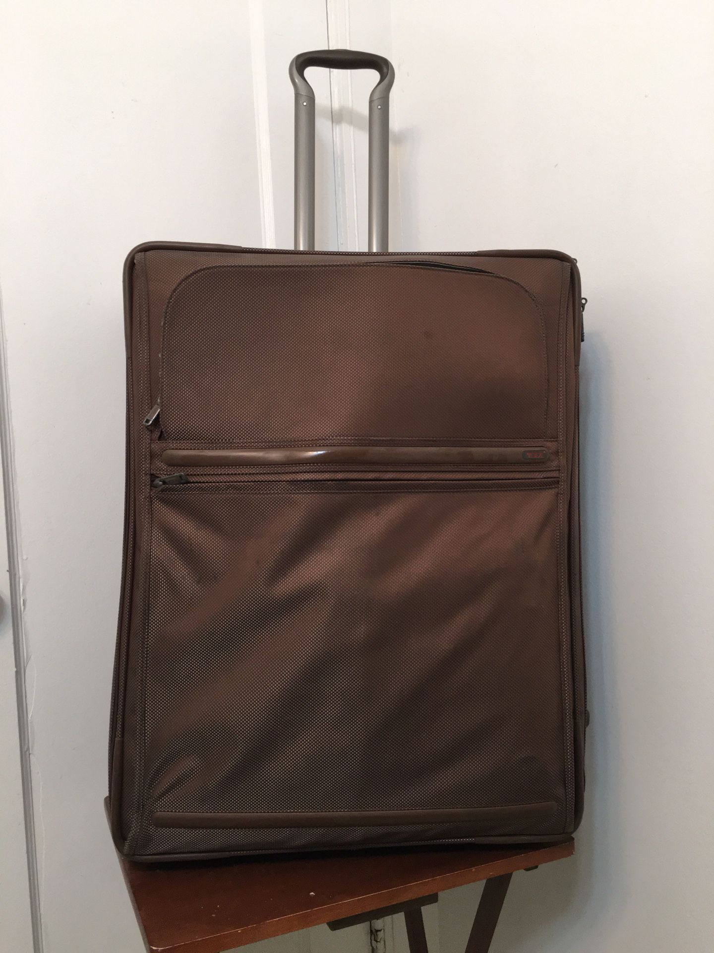 Tumi Travel Luggage  Bag with attachment of garment bag inside . Brown 26” Two Wheeled . Dimension 14x20x26.  Perfect and excellent condition and only