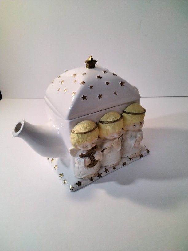 A Beautiful Tea Pot With Angels .