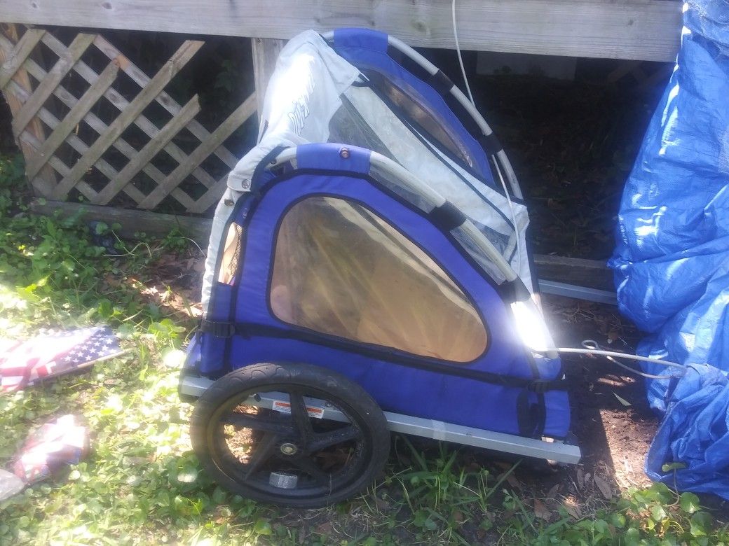 It is a bicycle trailer yes it is is a bicycle trailer yes it is a little kid