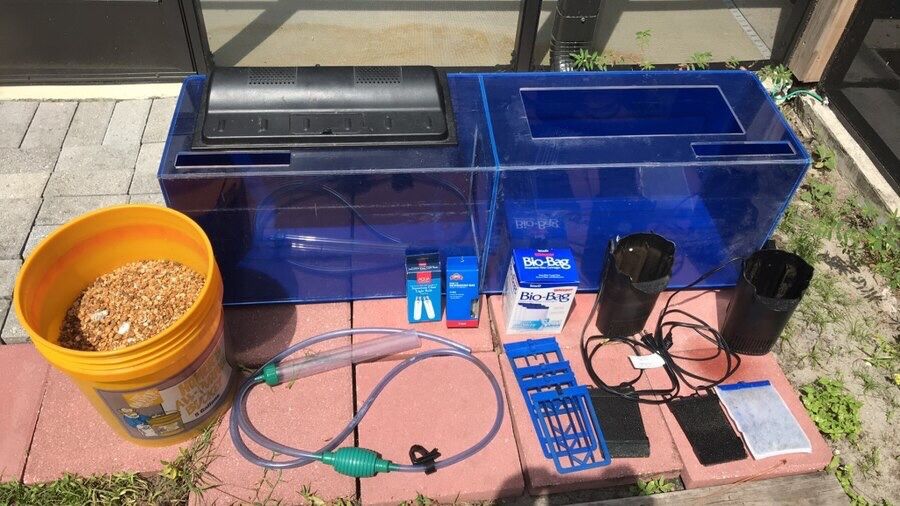 Fish tank with all necessary accessories: filter system, light and bulbs, bucket of gravel, gravel cleaner, fish not included but have goldfish and g
