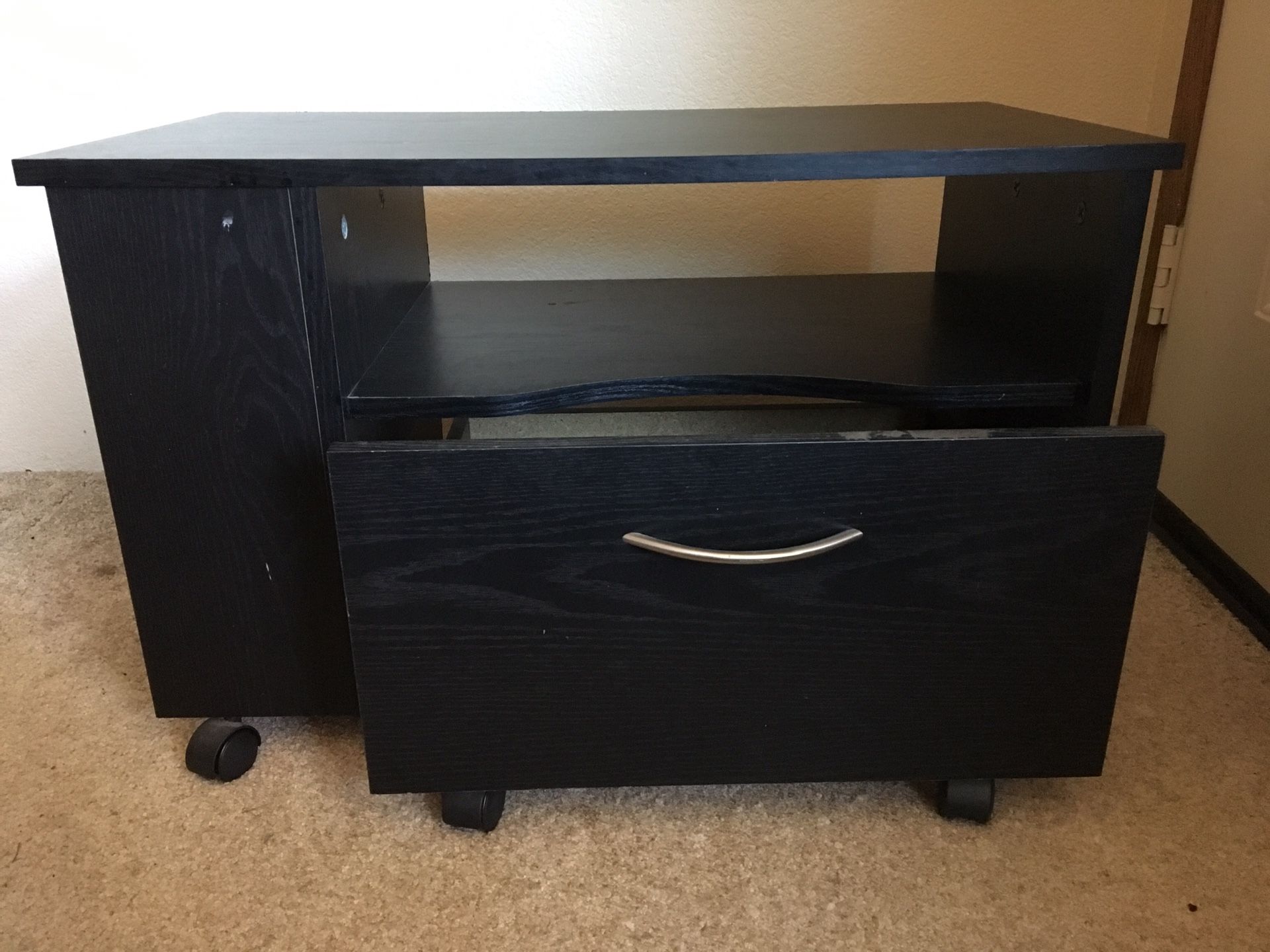 Small black stand with drawer.