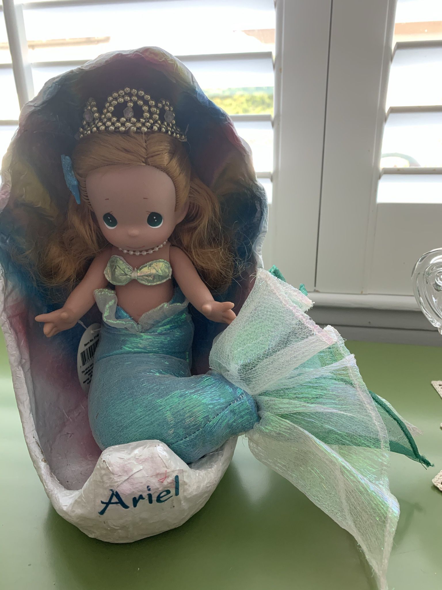 Disney Precious Moments Ariel in shell doll.  Soft body and vinyl head and arms.  Approx 10”H. She is in excellent condition. 