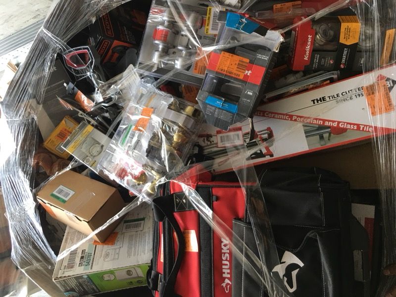 Pallet filled with locks, tools, and hardware for resale