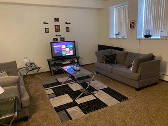 Living room set , with one couch , end tables , rug , tv and stand . Thumbnail