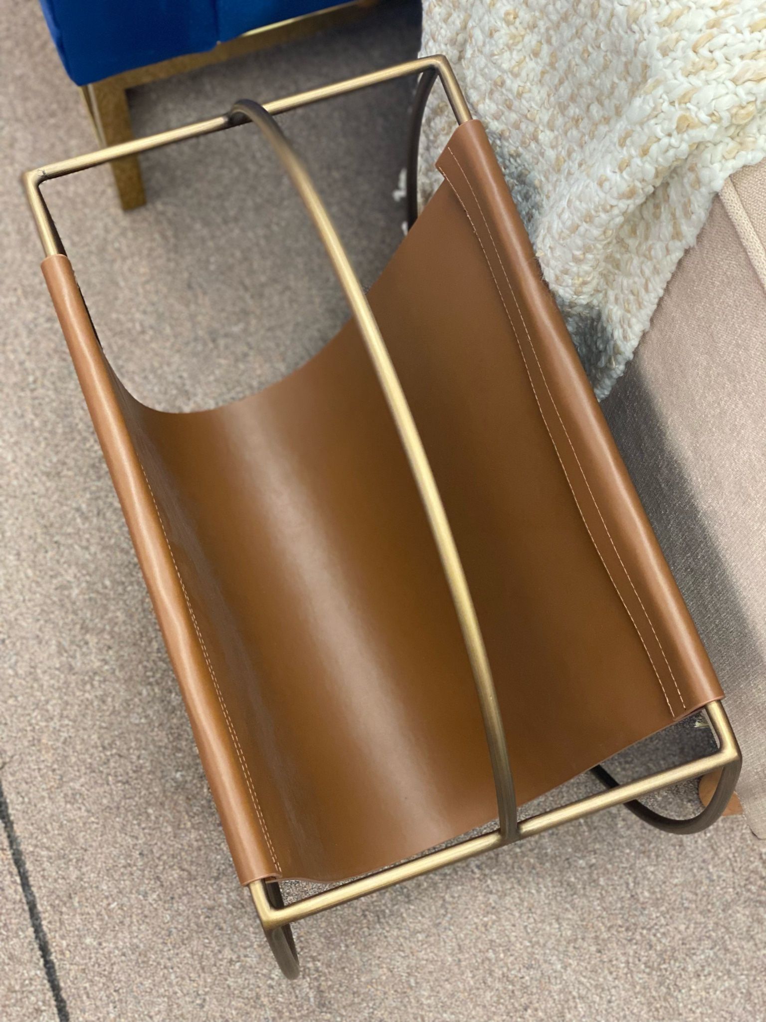 Hardage magazine rack by Mercury Row. Overall: 23” H x 22” W x 10” D. Faux leather. MSRP: $300. Our price: $95 + Sales tax