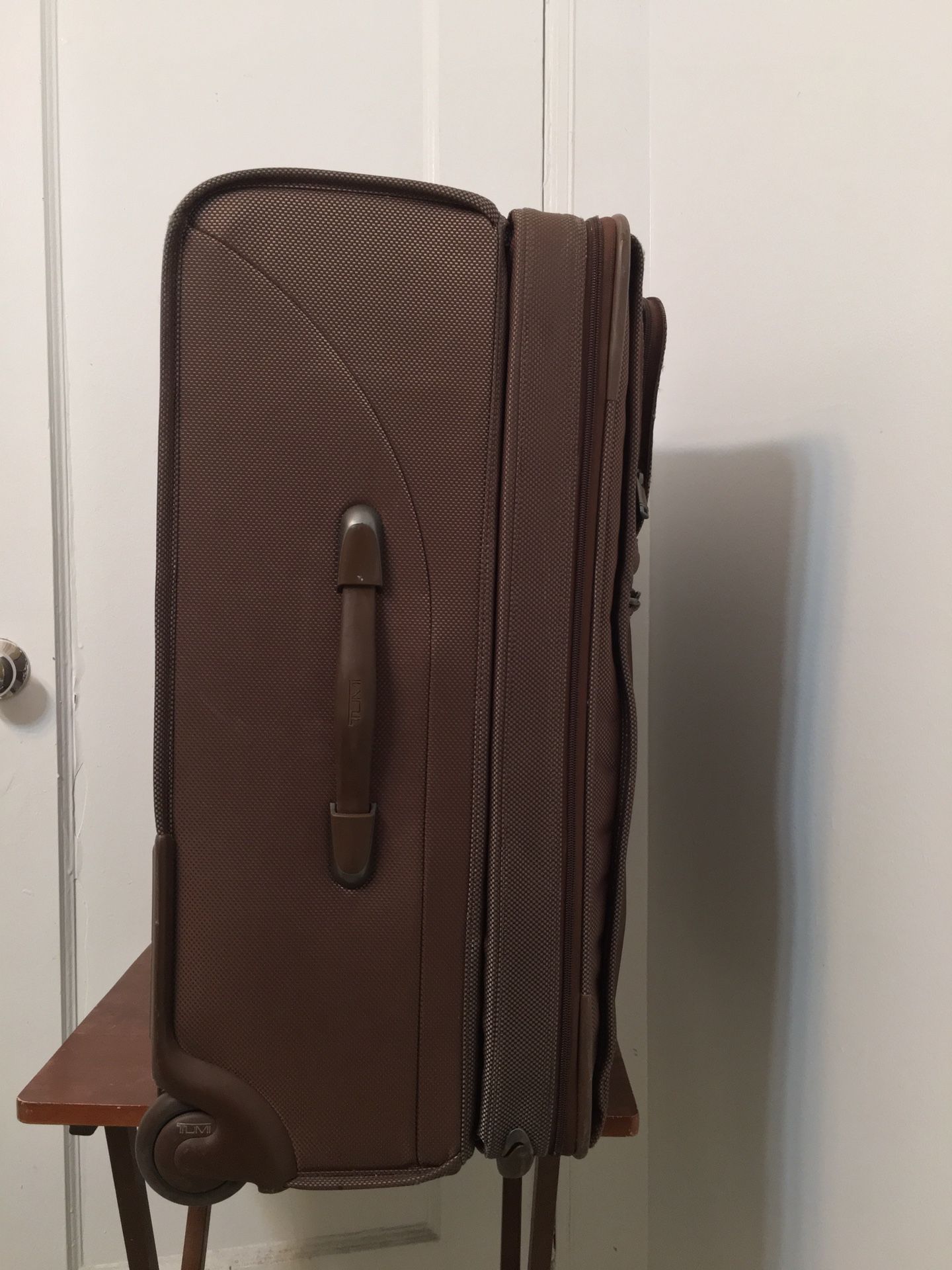 Tumi Travel Luggage Bag with attachment of garment bag inside . Brown 26” Two Wheeled . Dimension 14x20x26. Perfect and excellent condition and only