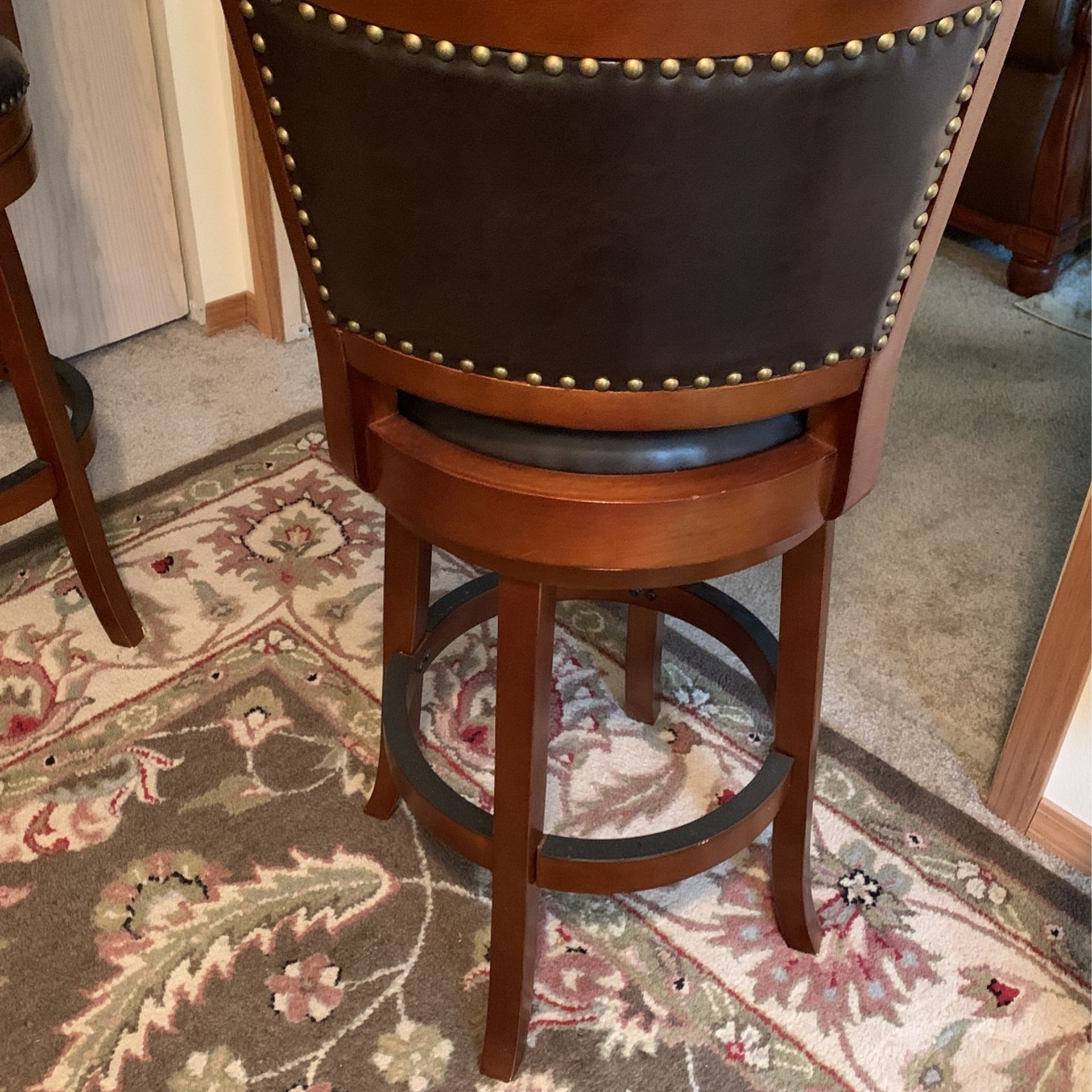 Swivel Bar Stools Black Leather+Cherry Wood+Brass Tacks . Floor to Seat 29”. Floor to top Of The Back 42”.