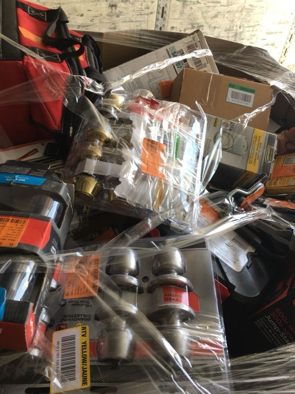 Pallet filled with locks, tools, and hardware for resale