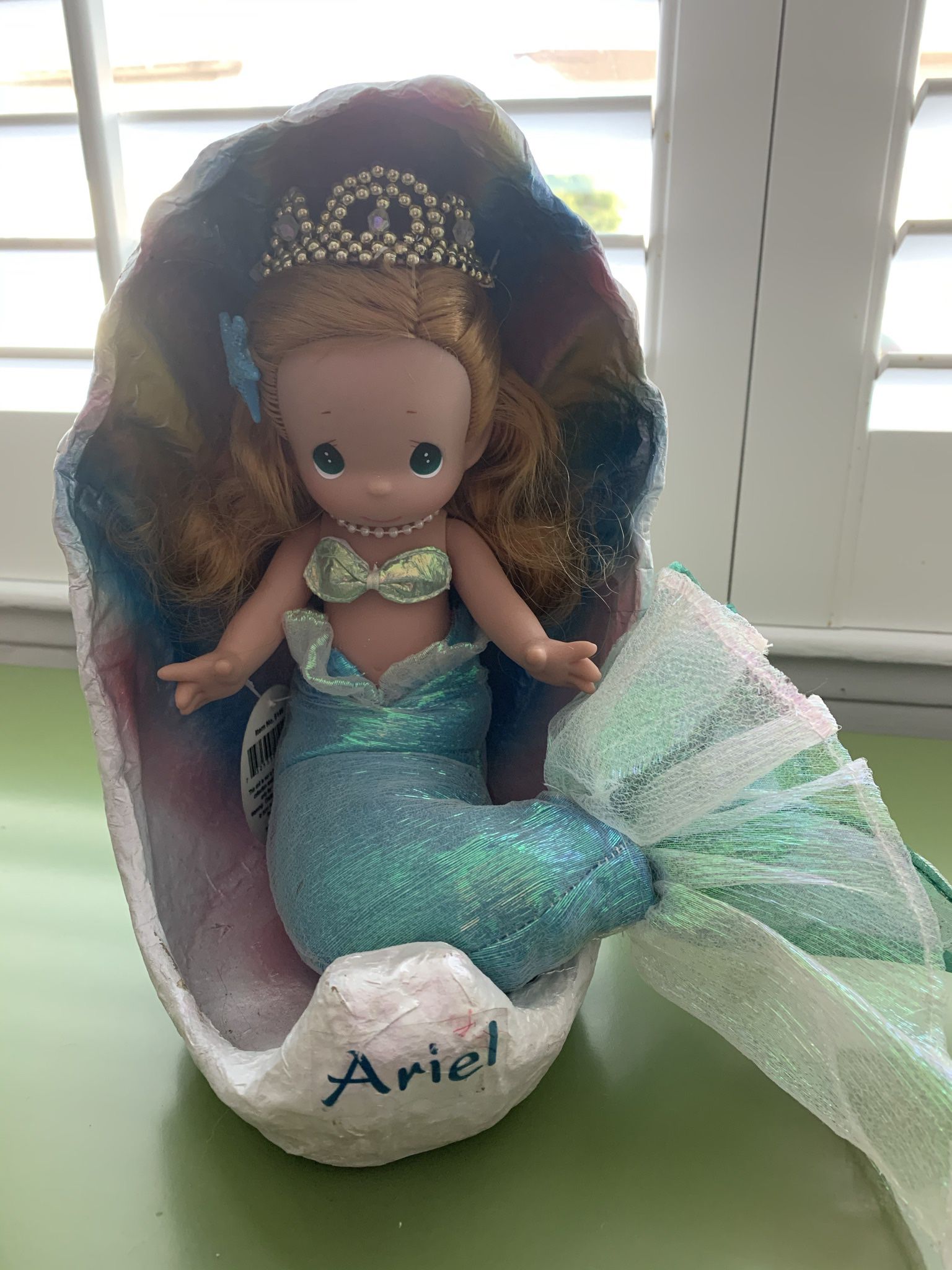 Disney Precious Moments Ariel in shell doll.  Soft body and vinyl head and arms.  Approx 10”H. She is in excellent condition. 