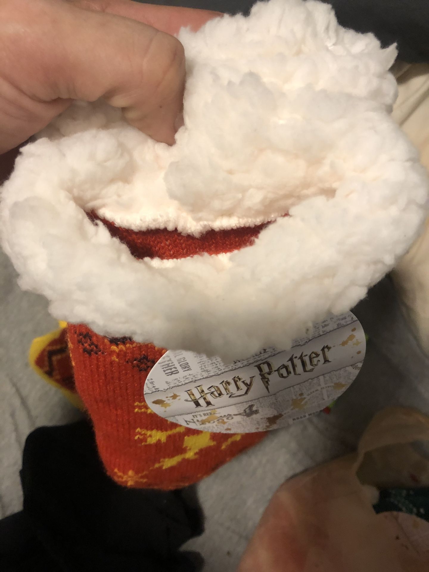 Harry Potter one size fits ok gryffondor house with the logo at the bottom . With the lion in the middle never worn selling for less than half retail