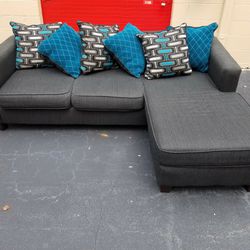 Nice Charcoal Gray Sectional w/ Grey and Blue Pillows Thumbnail