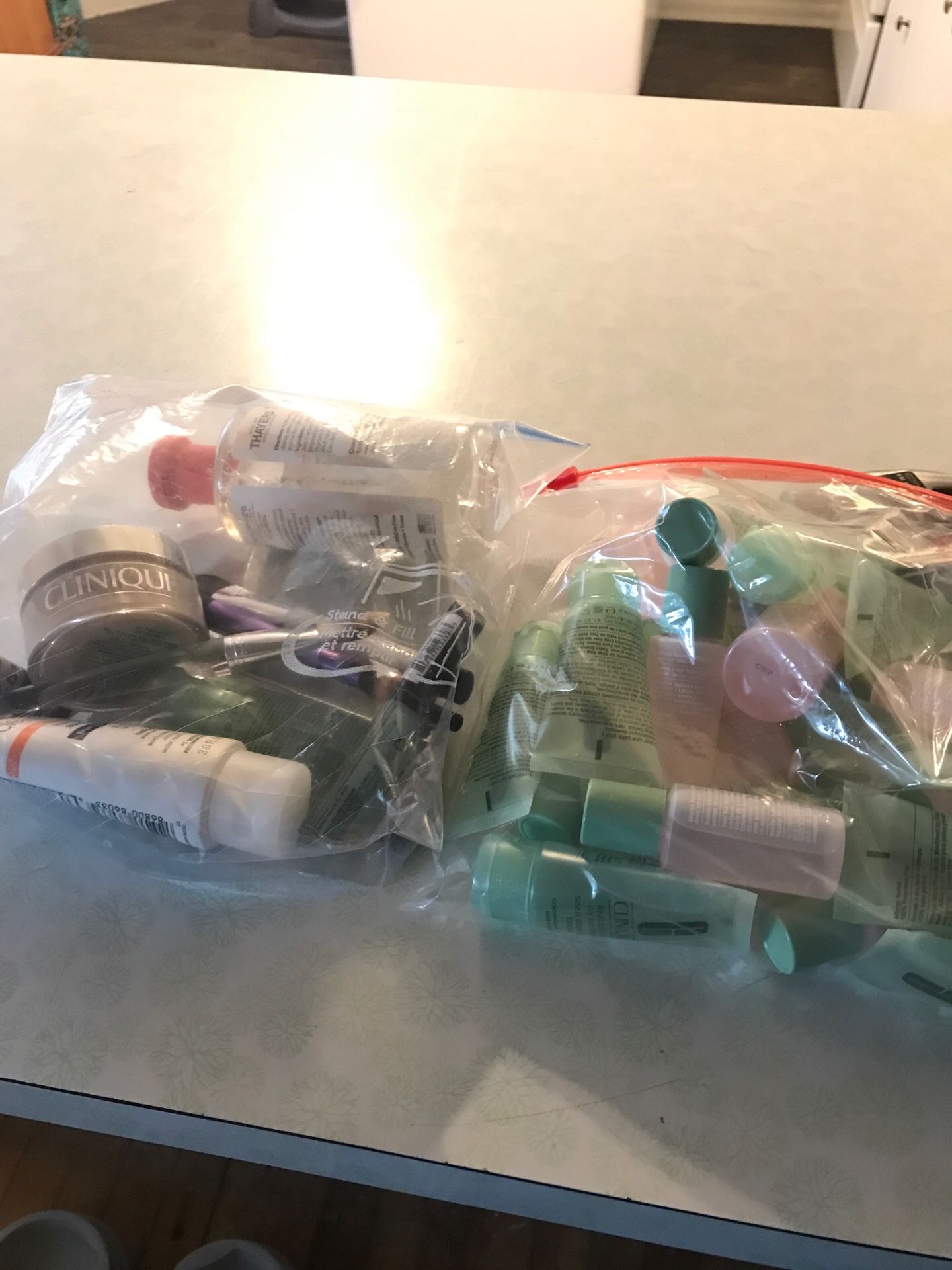 Bags full of face cleaner , makeup brushes, and a few pieces of makeup