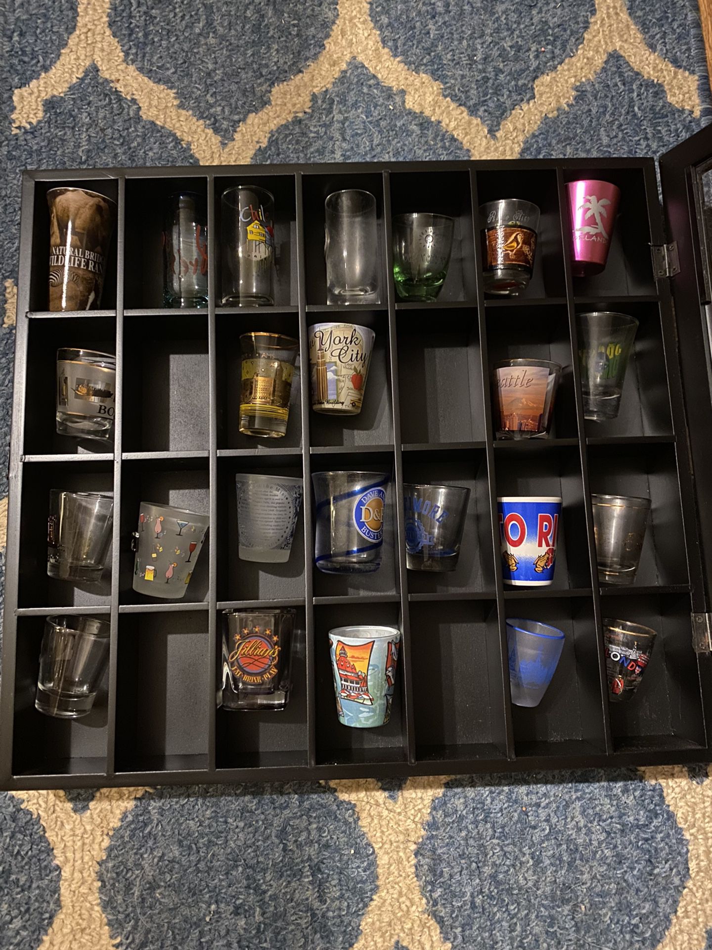 Case Of Shot Glasses From Various Cities Throughout The World