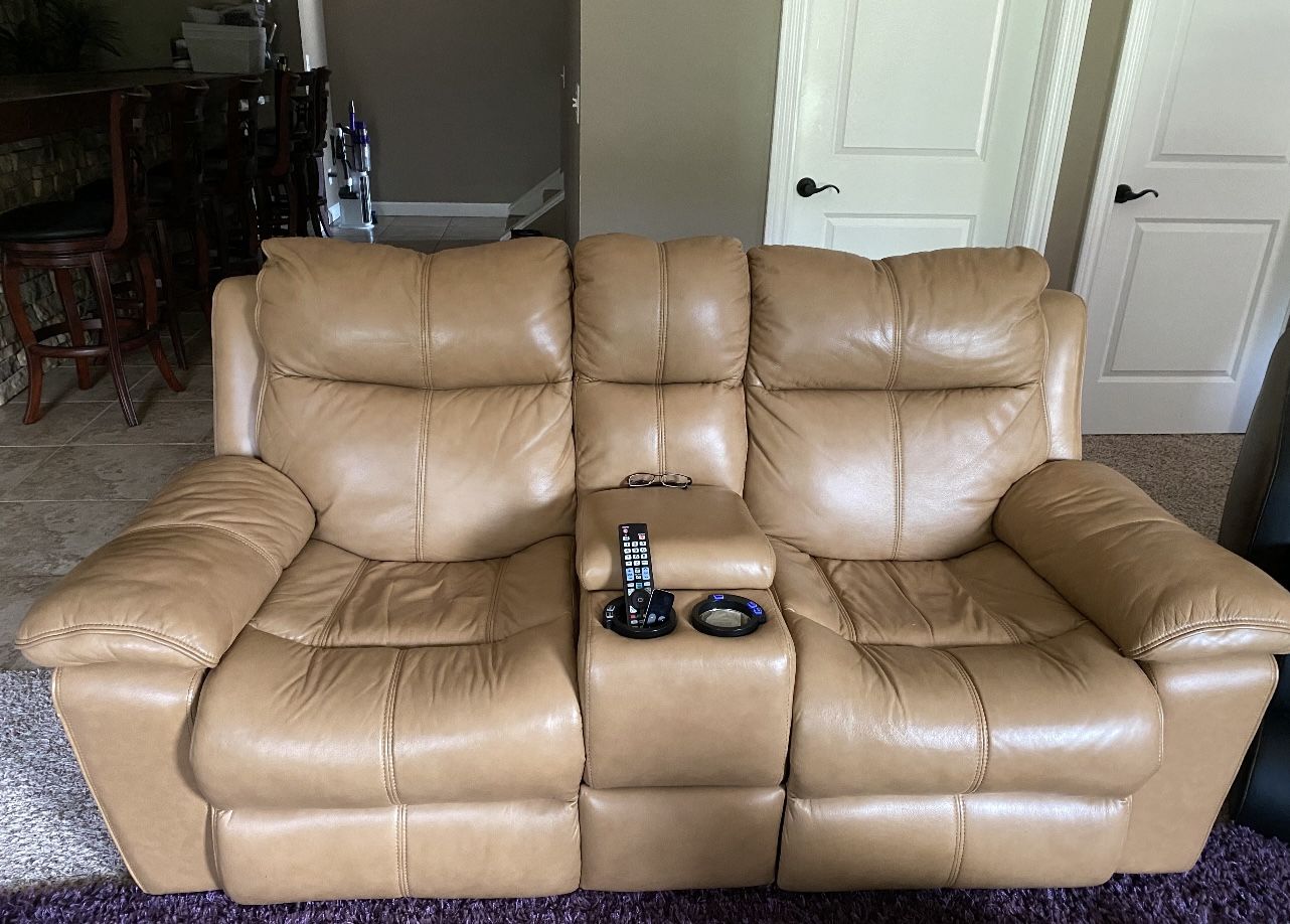 Tan leather sofa set is for sale Ana- they are power recliners. Price 1600
