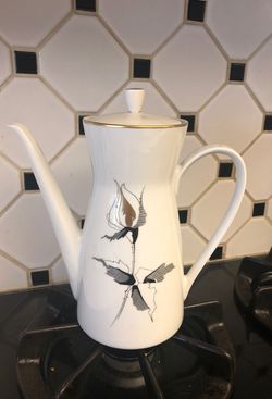 Vintage porcelain tea kettle it holds 5 cups.