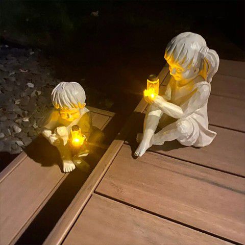 Creatively Statues Of 2 Kids Holding Fireflies.