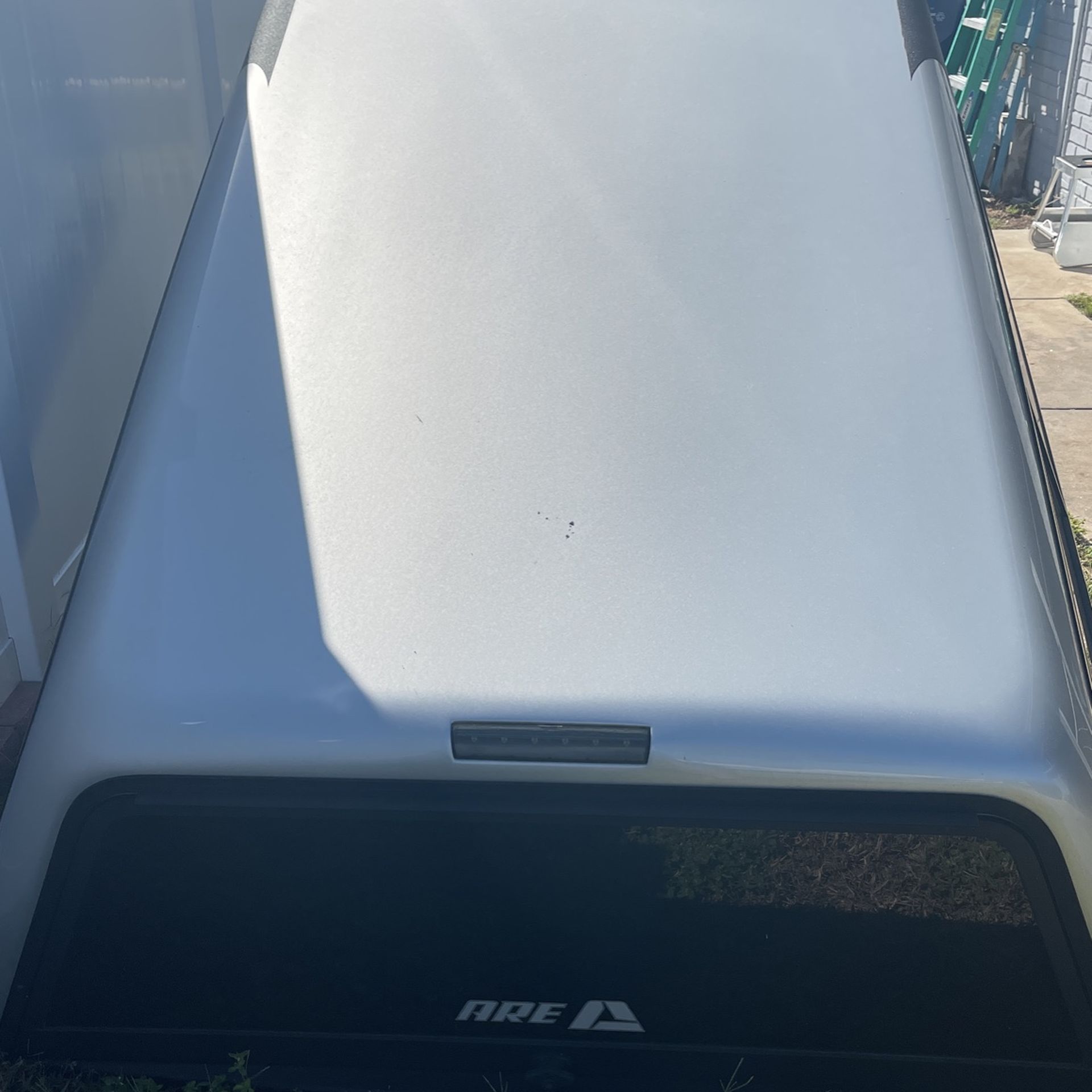 2016 silver Chevy Silverado Are Fiberglass topper