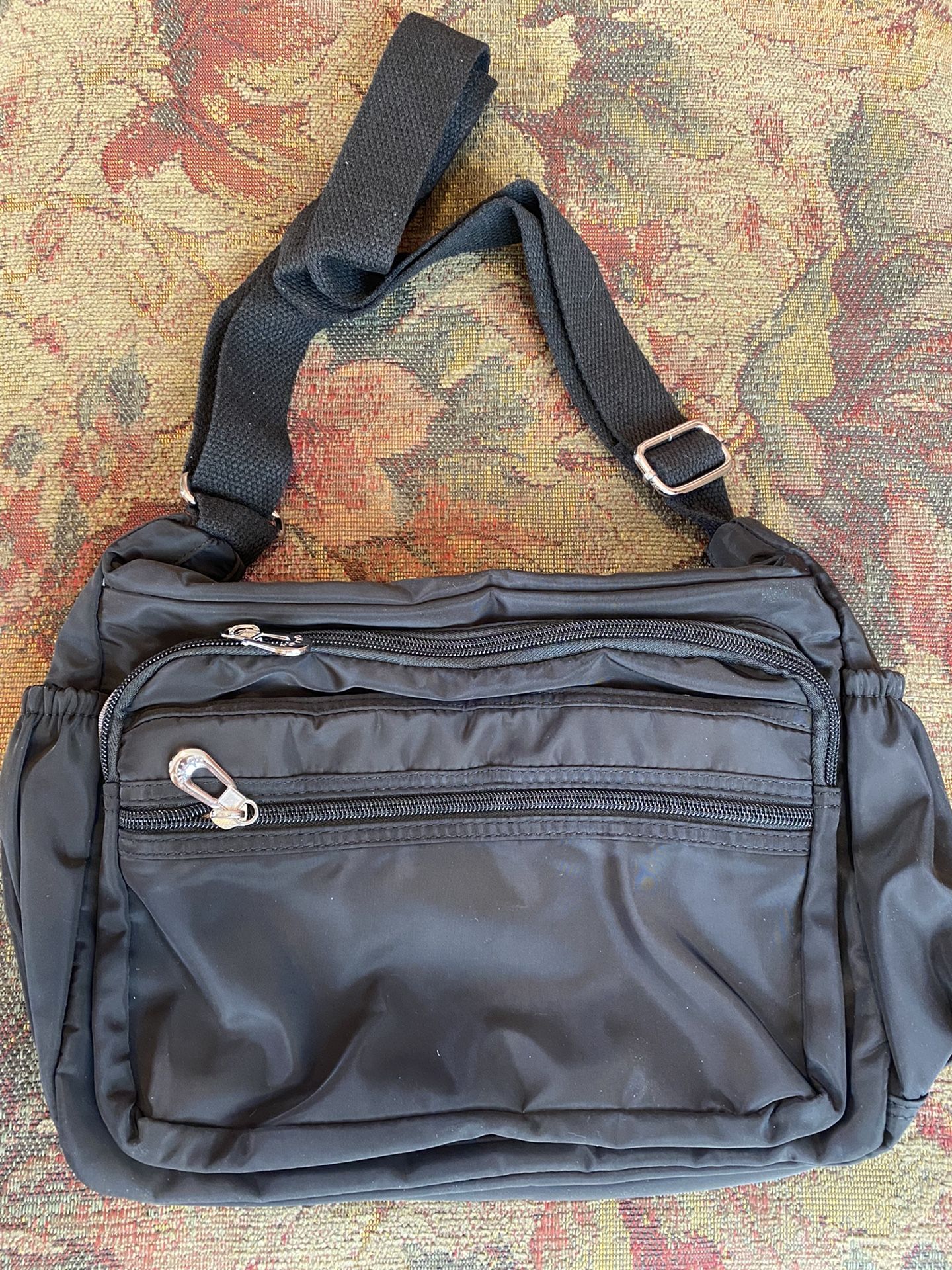 Black over-the-shoulder, multi-compartment bag