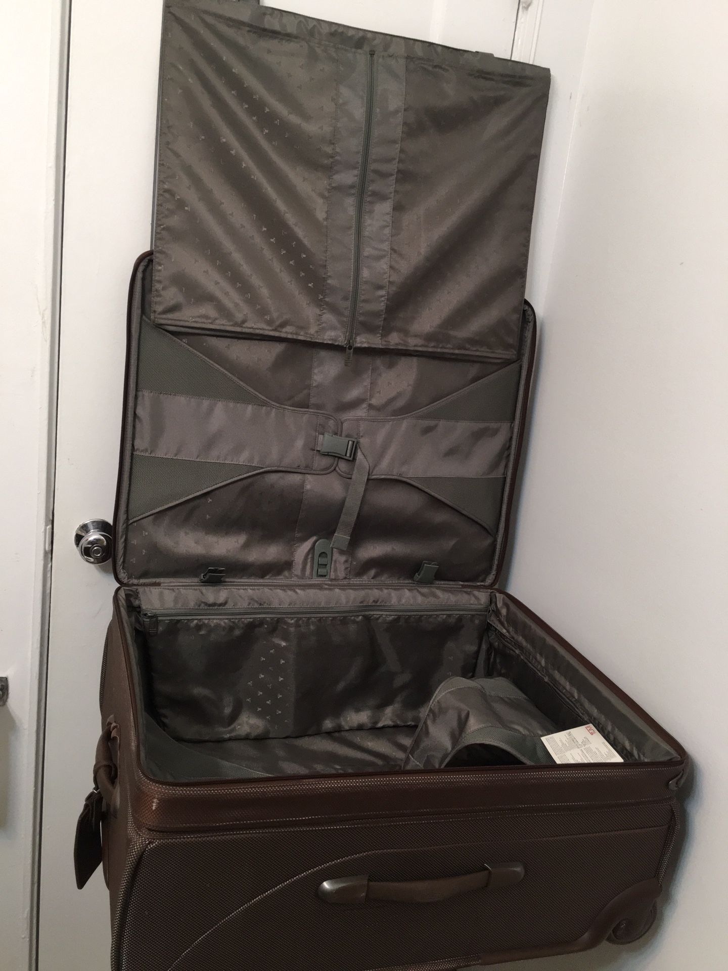 Tumi Travel Luggage  Bag with attachment of garment bag inside . Brown 26” Two Wheeled . Dimension 14x20x26.  Perfect and excellent condition and only