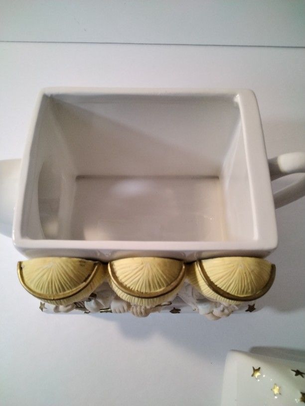 A Beautiful Tea Pot With Angels .