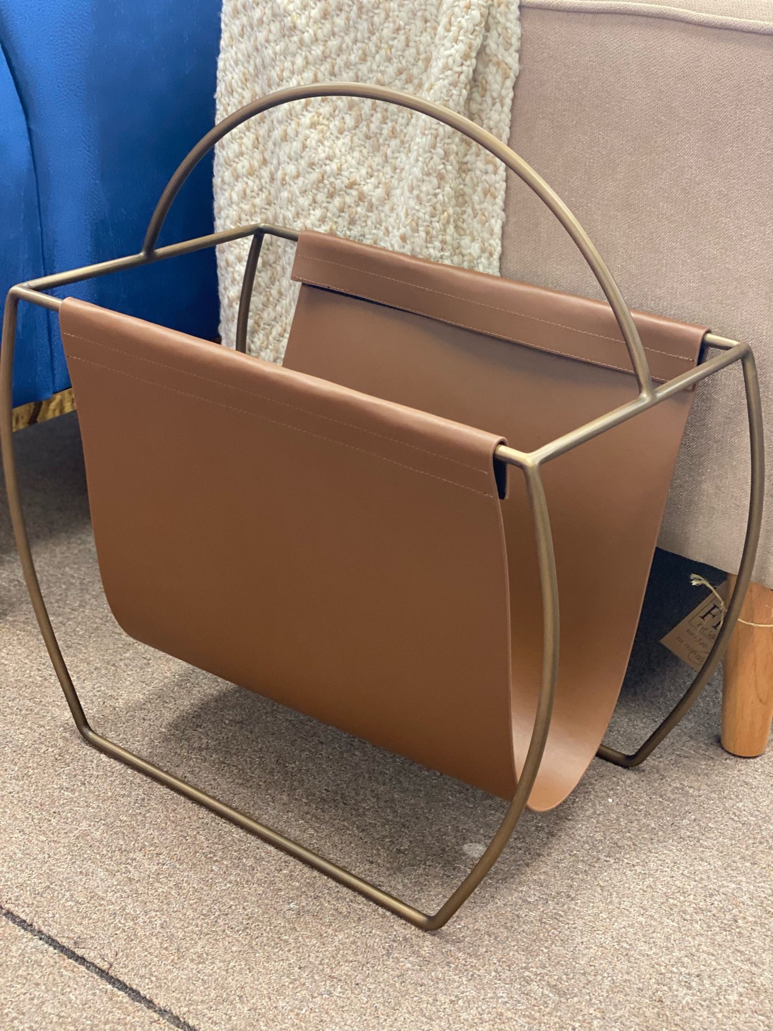 Hardage magazine rack by Mercury Row. Overall: 23” H x 22” W x 10” D. Faux leather. MSRP: $300. Our price: $95 + Sales tax