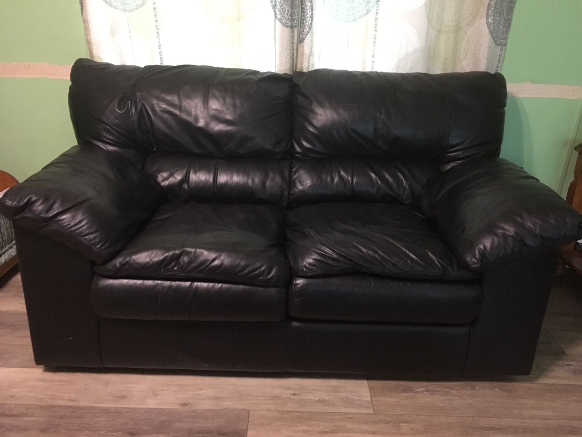 Black leather love seat and oversized chair