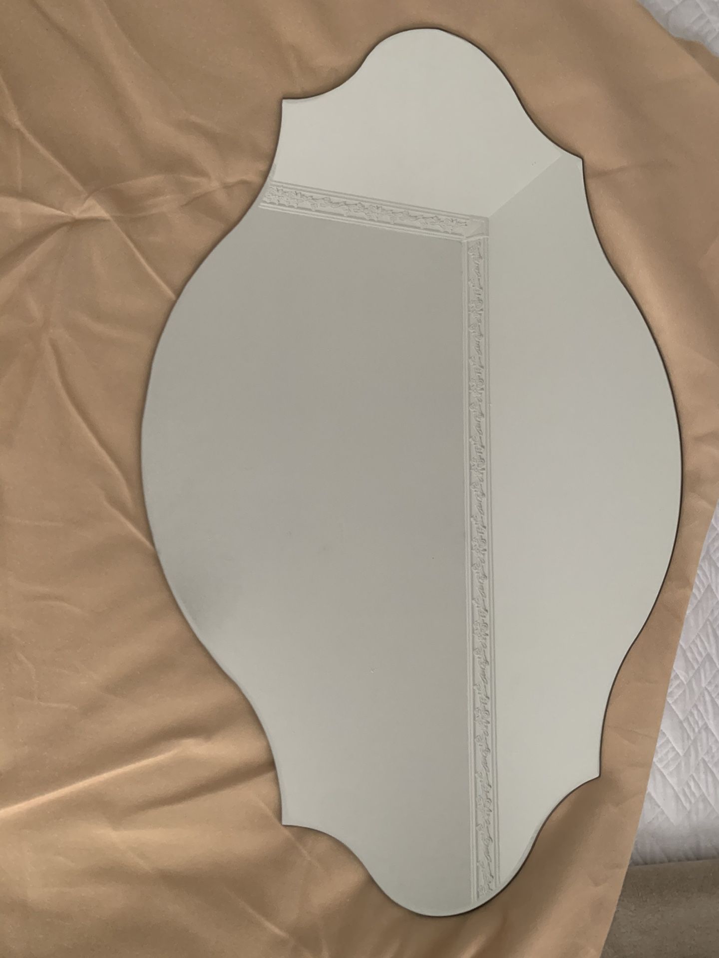 Oval frameless wall mirror