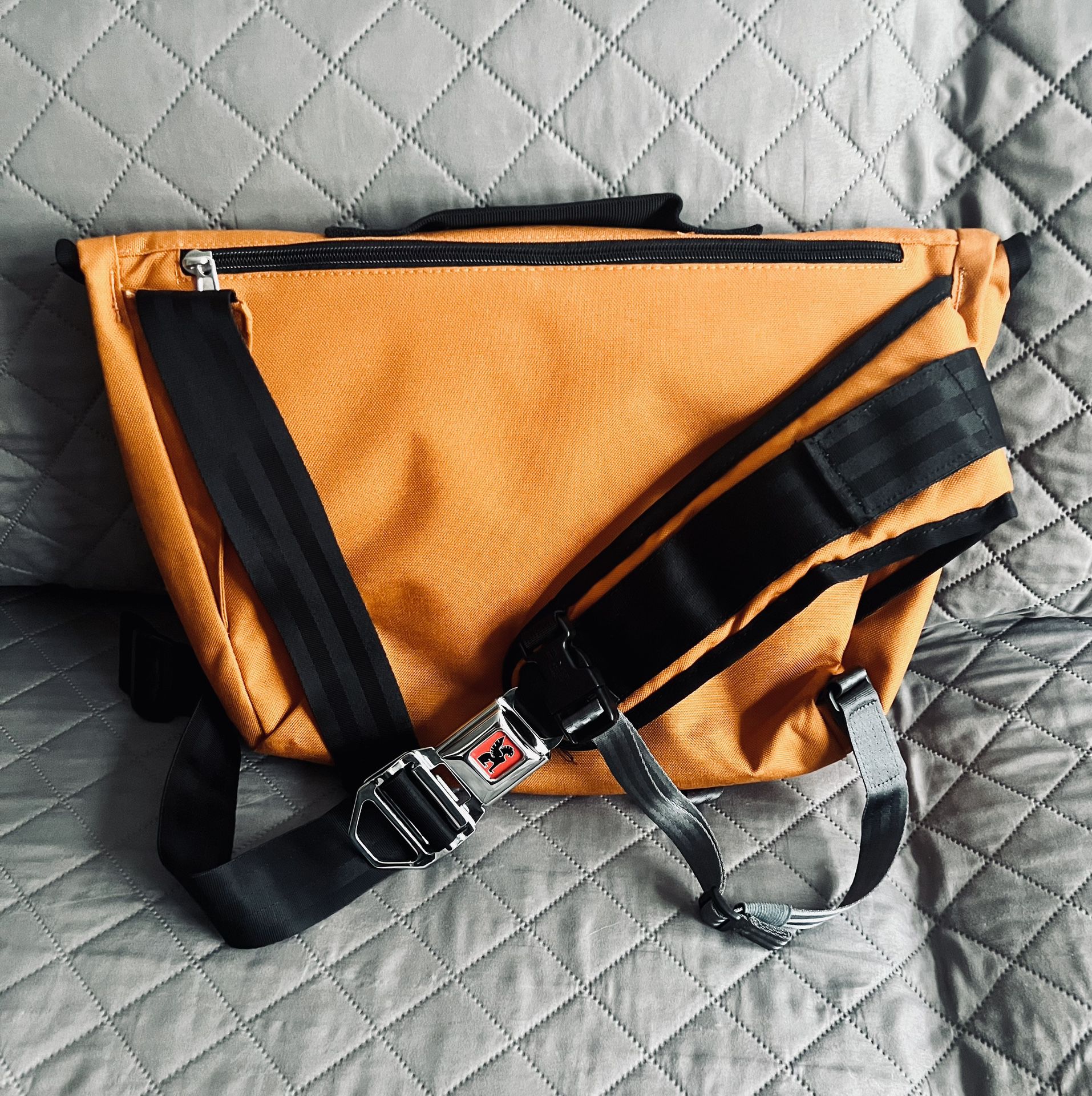 Chrome citizen messenger cross body bag with seat belt buckle in orange
