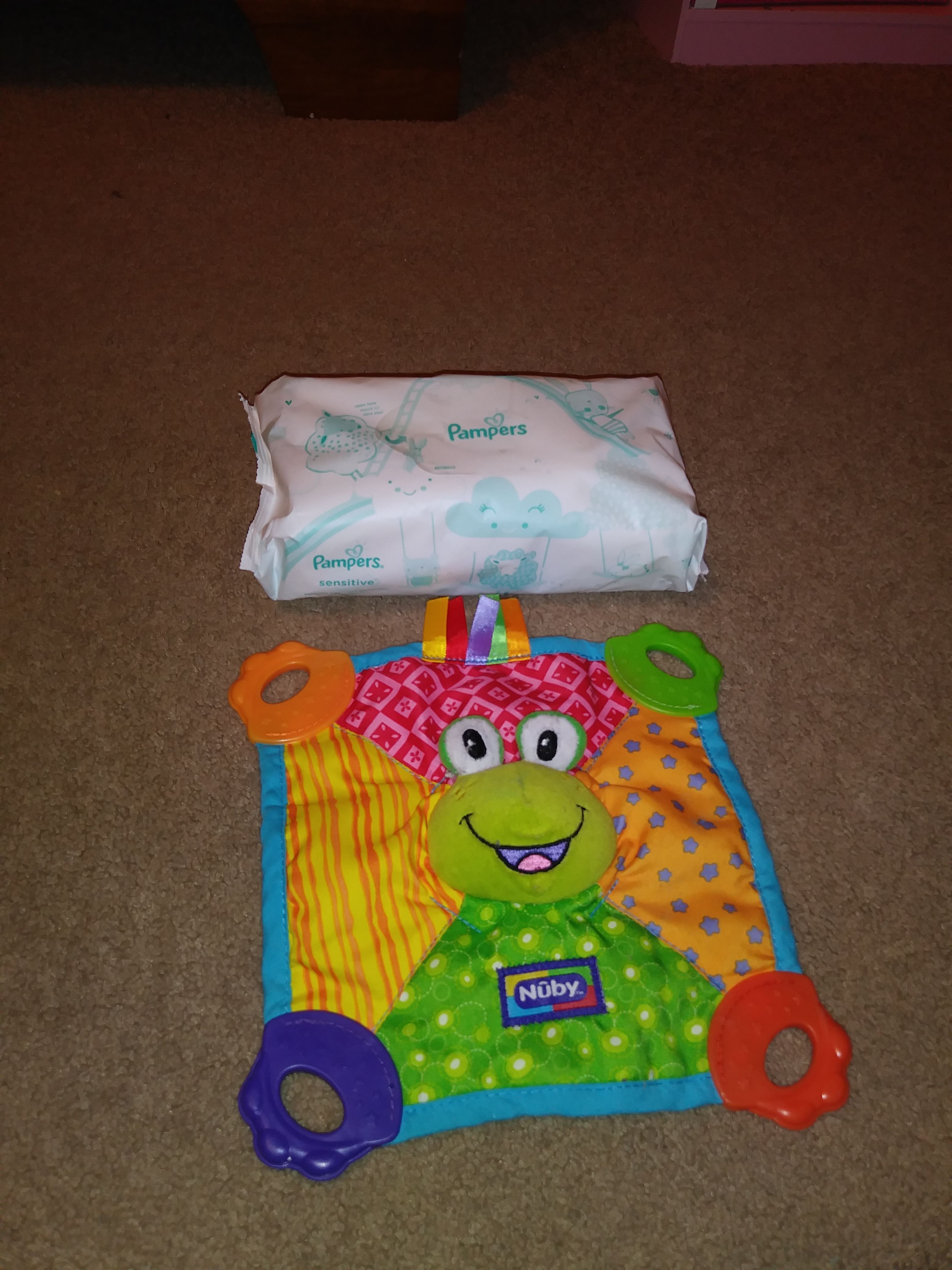 Grey Bompy Pillow with White Elephants and Pampers Wipes and Nuby Teether