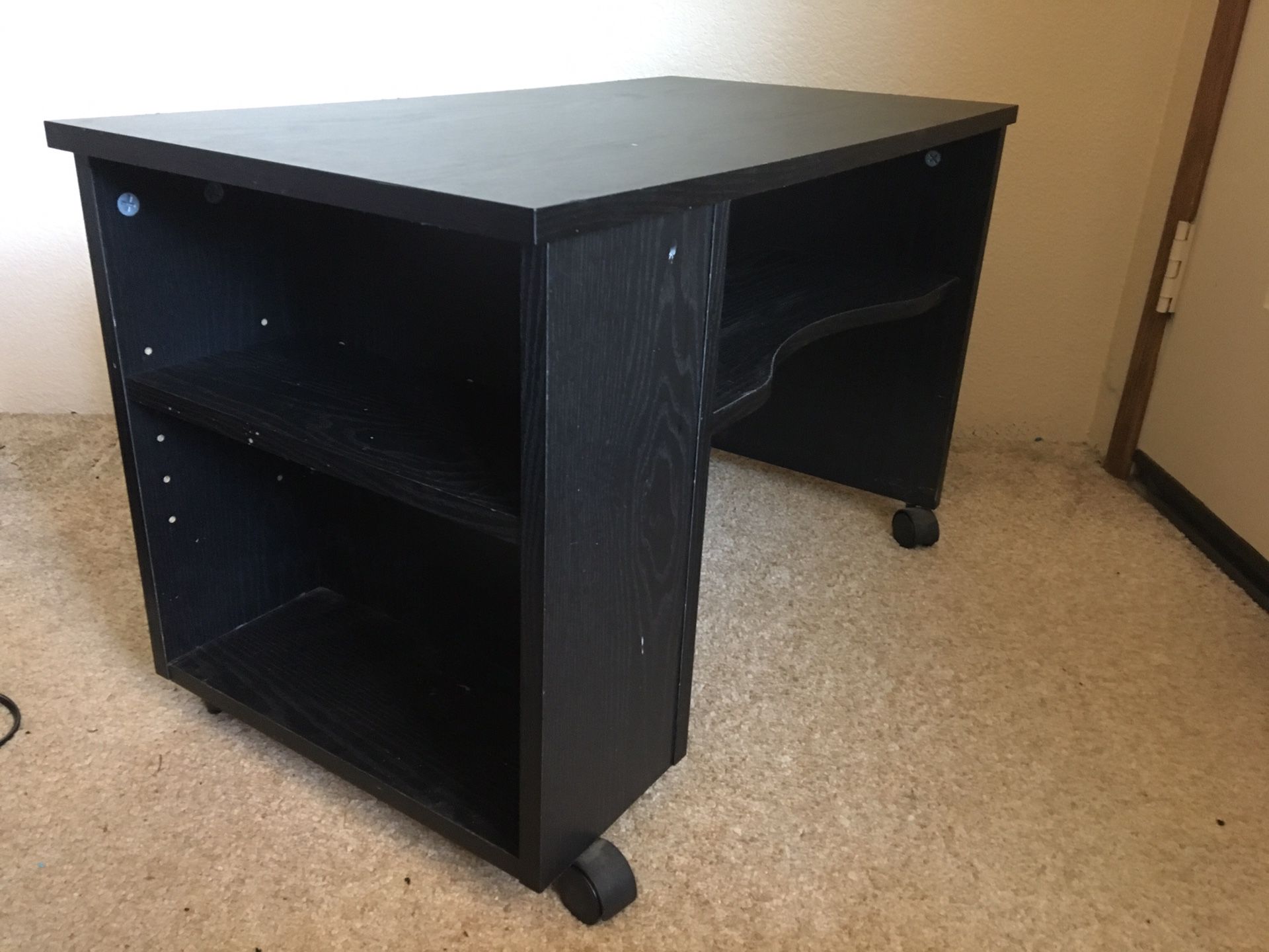 Small black stand with drawer.