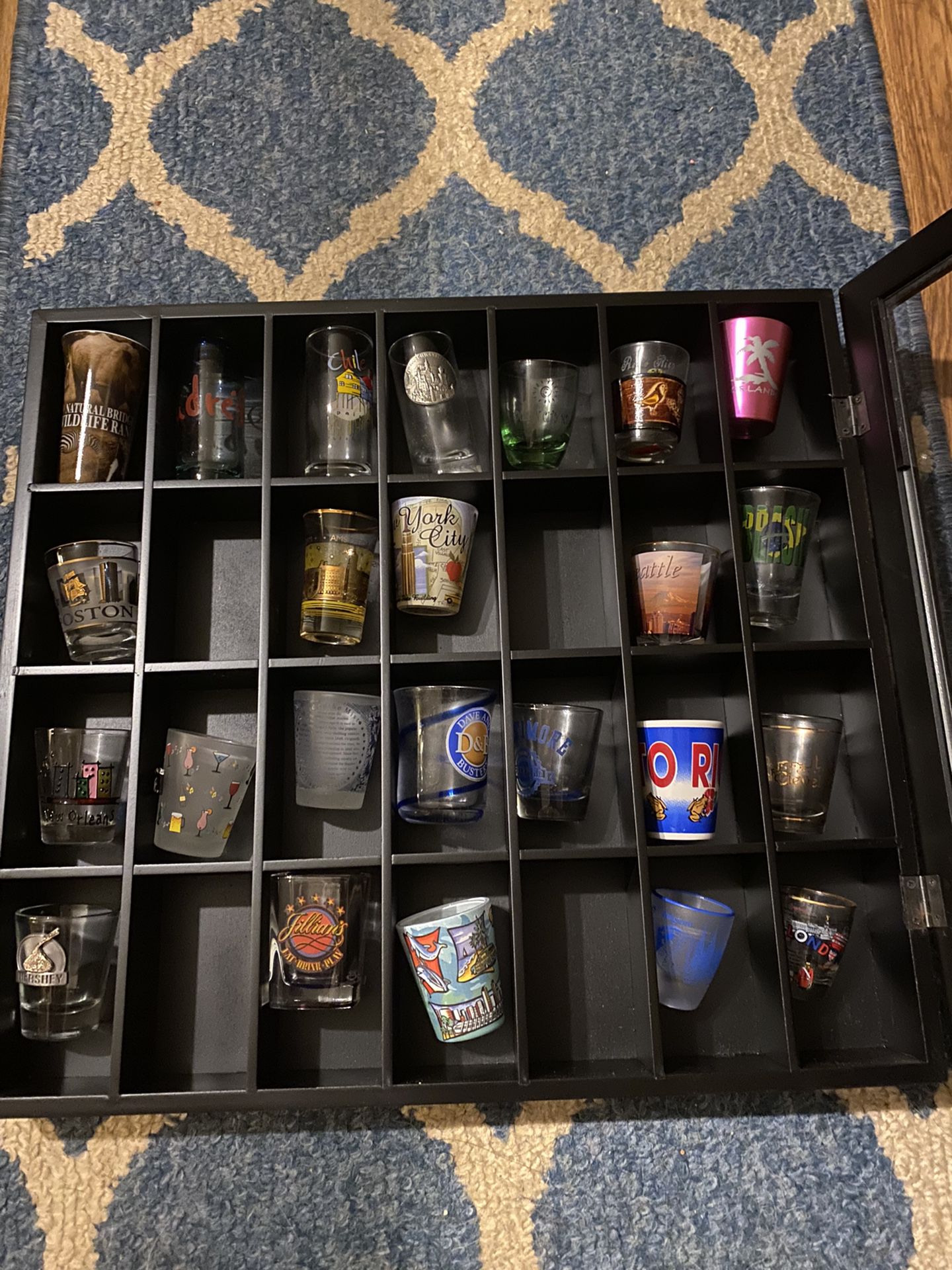 Case Of Shot Glasses From Various Cities Throughout The World