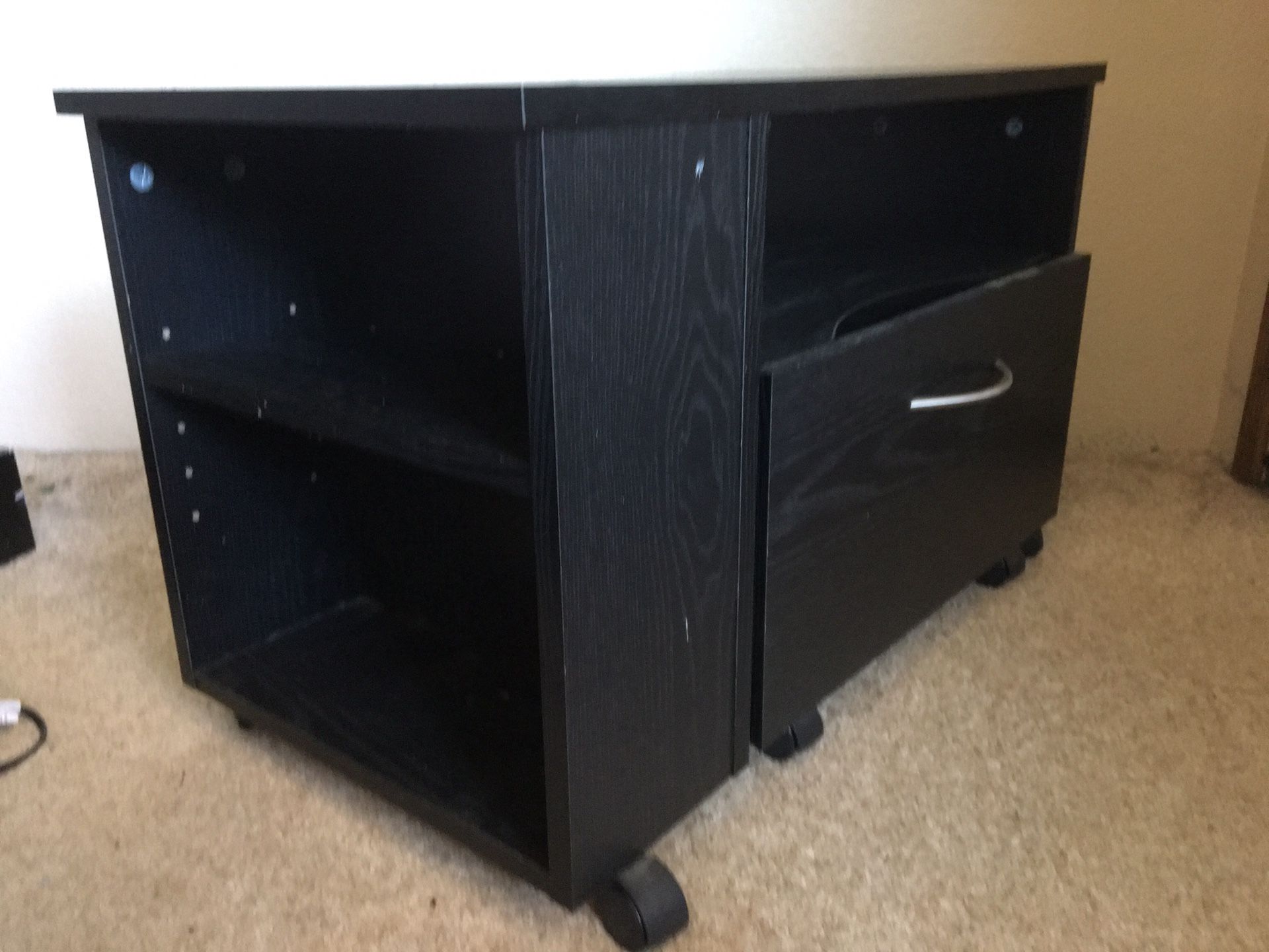 Small black stand with drawer.