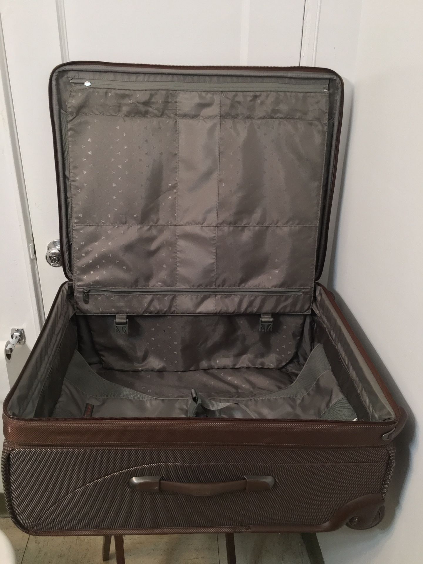 Tumi Travel Luggage Bag with attachment of garment bag inside . Brown 26” Two Wheeled . Dimension 14x20x26. Perfect and excellent condition and only