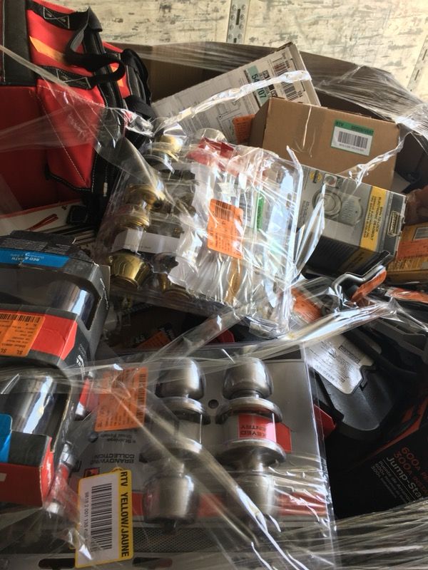 Pallet filled with locks, tools, and hardware for resale