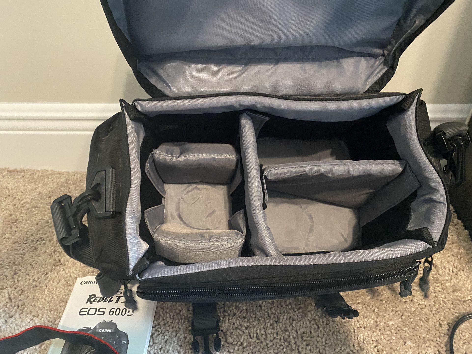 Excellent condition Canon EOS Rebel camera with two lenses, battery charger, and large camera bag.