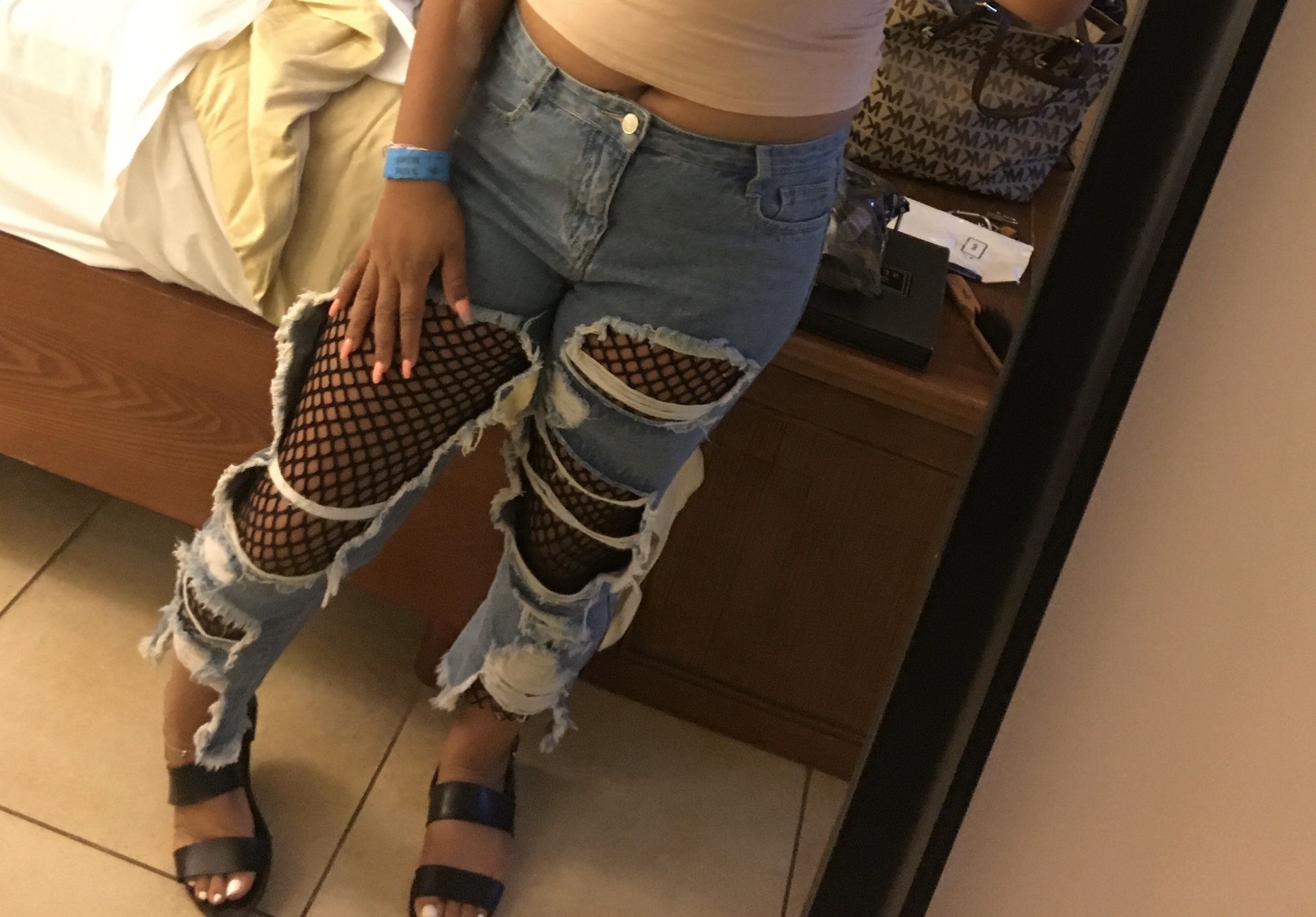 Distressed jeans with fishnet stockings