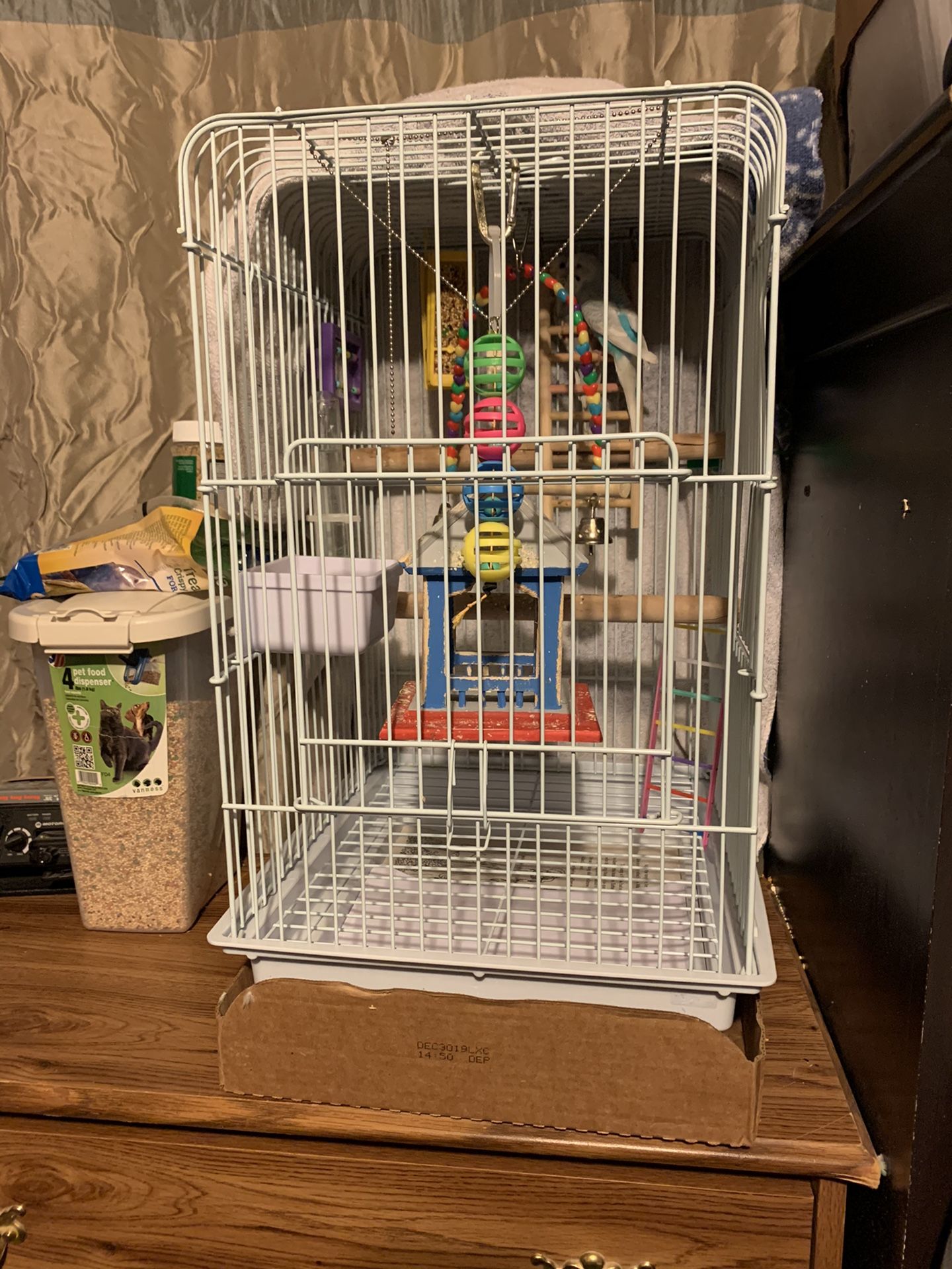 2 parakeets, the cage with stand and food