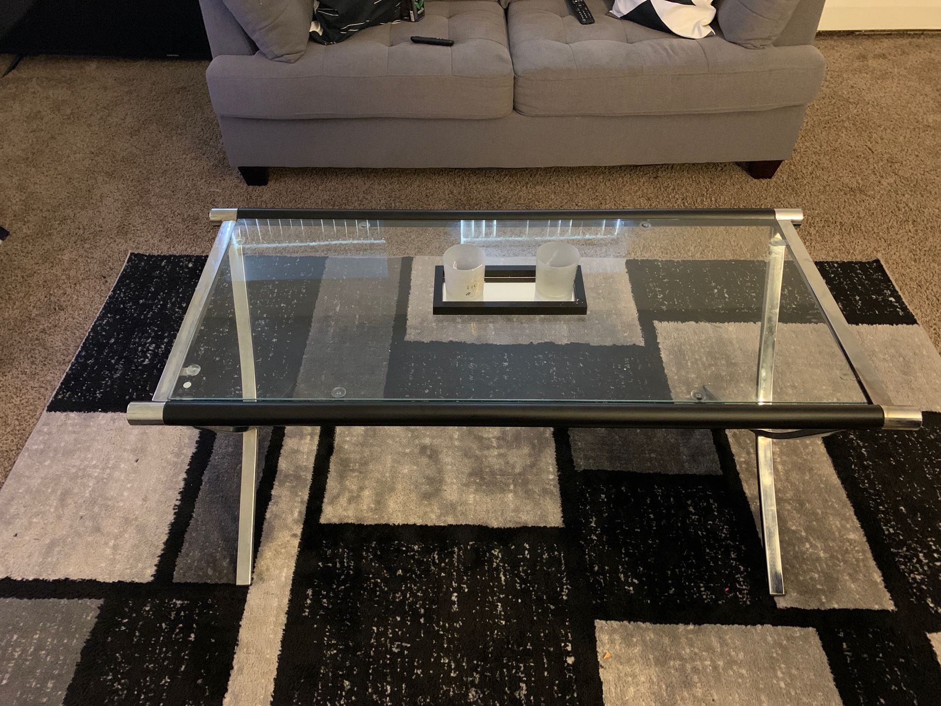 Living room set , with one couch , end tables , rug , tv and stand .