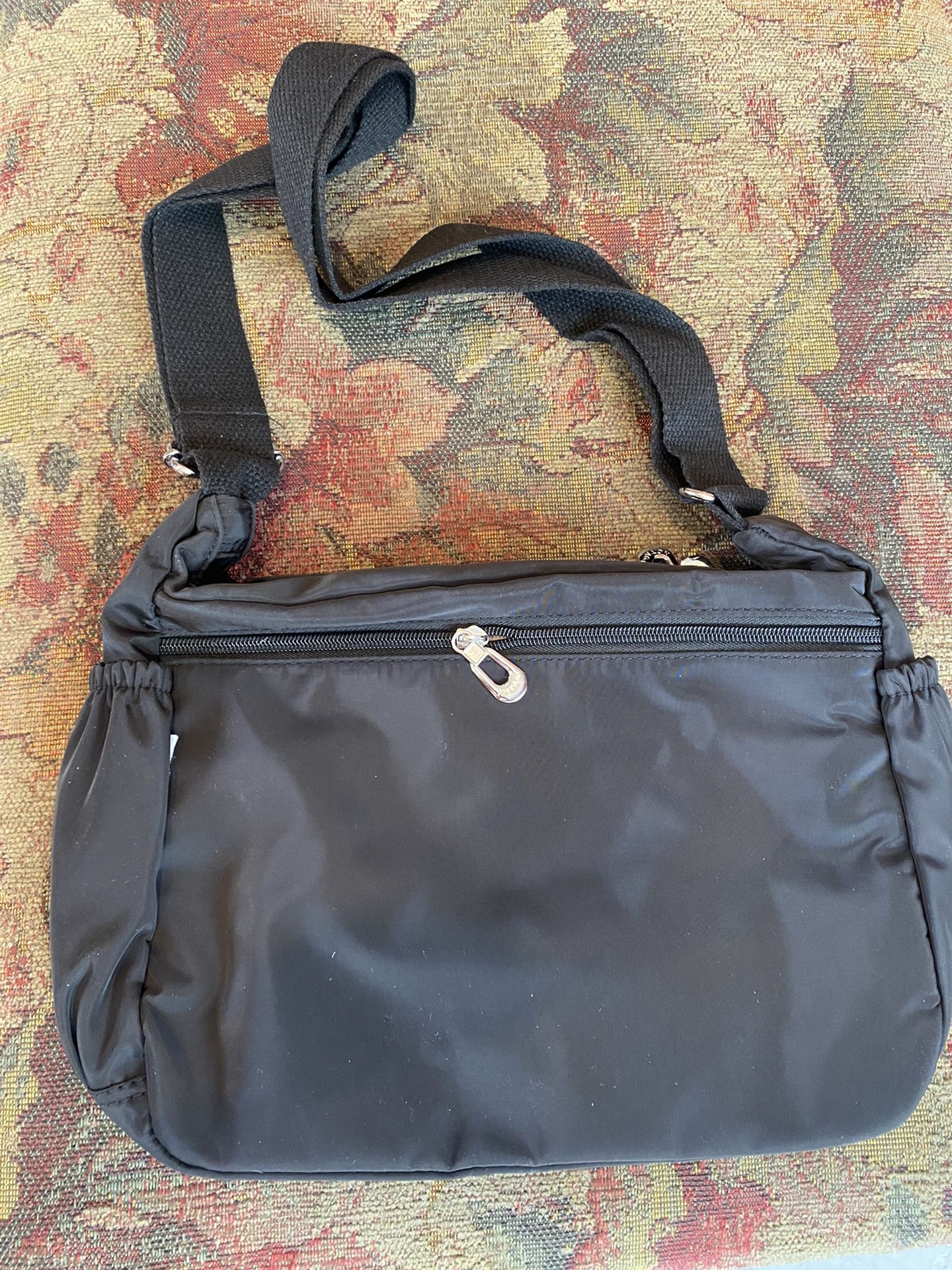 Black over-the-shoulder, multi-compartment bag