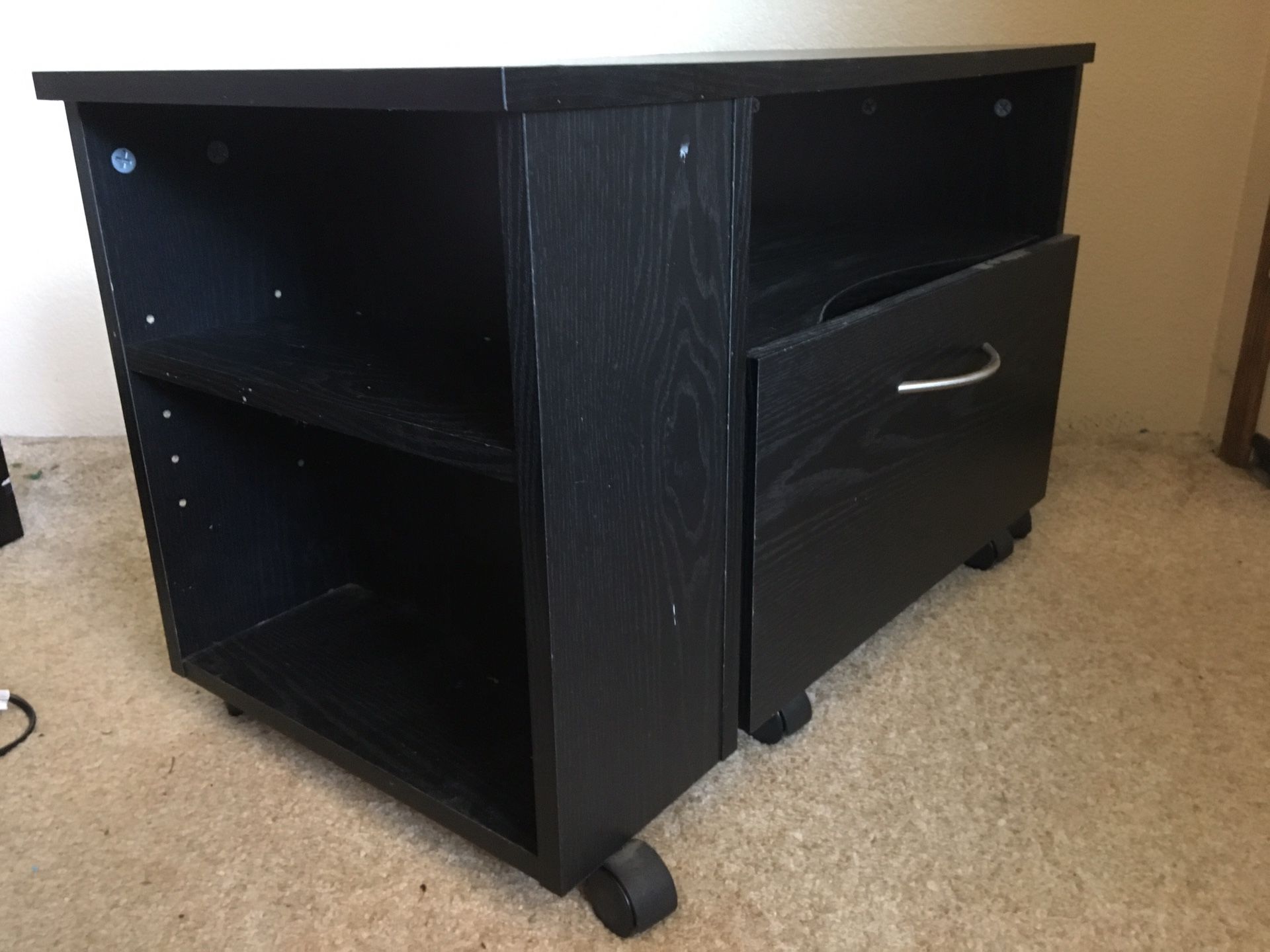 Small black stand with drawer.