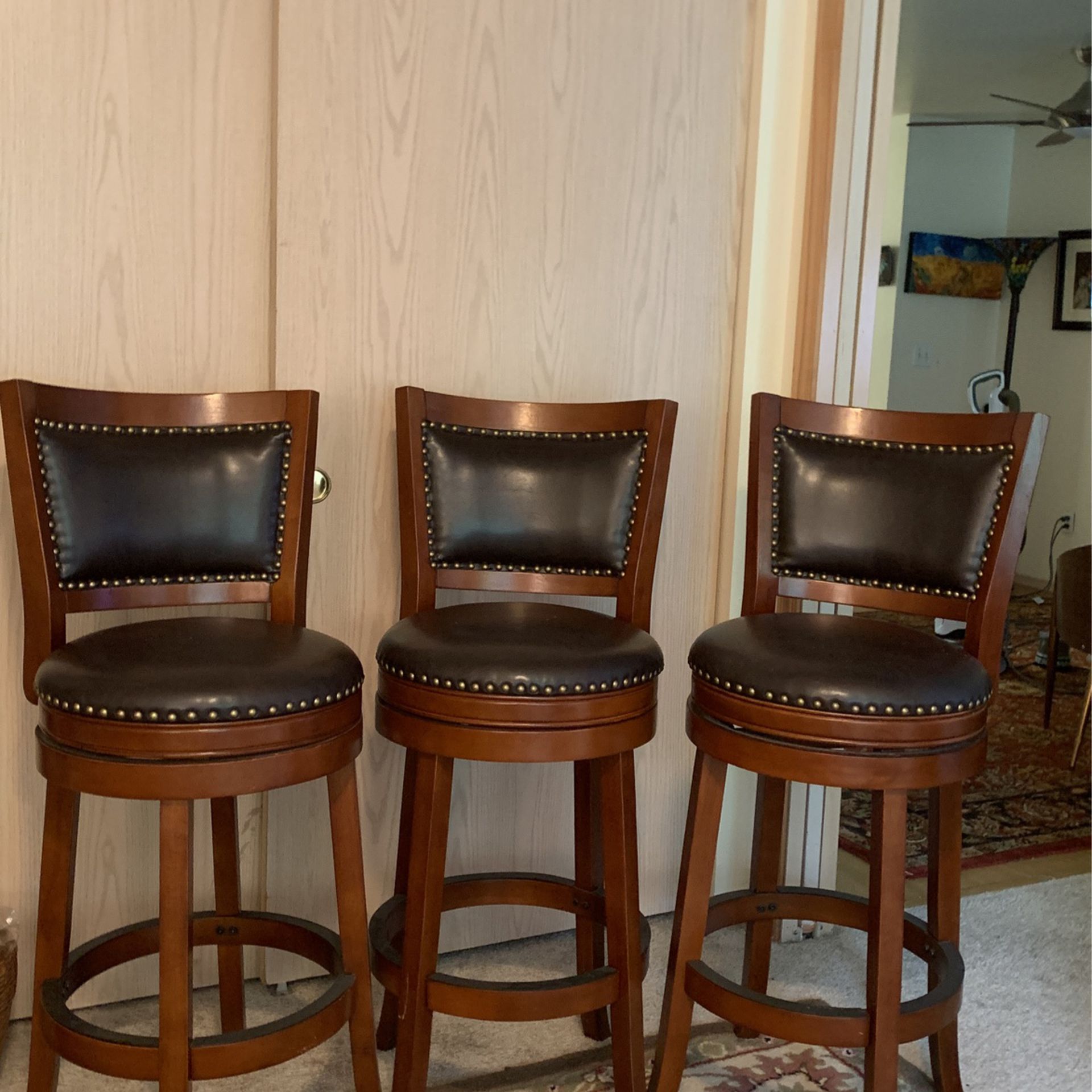 Swivel Bar Stools Black Leather+Cherry Wood+Brass Tacks . Floor to Seat 29”. Floor to top Of The Back 42”.