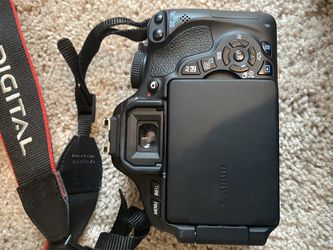 Excellent condition Canon EOS Rebel camera with two lenses, battery charger, and large camera bag. Thumbnail